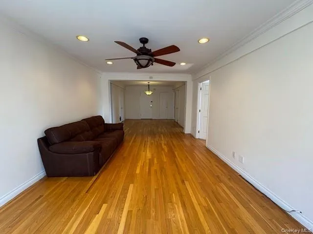 Living room with crown molding, light wood-style flooring, recessed lighting, and ceiling fan Living room with crown molding, light wood-style flooring, recessed lighting, and ceiling fan