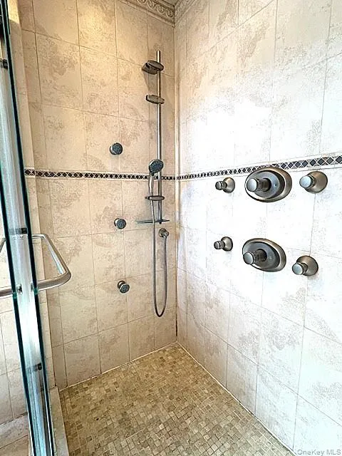 Bathroom with a shower stall Bathroom with a shower stall