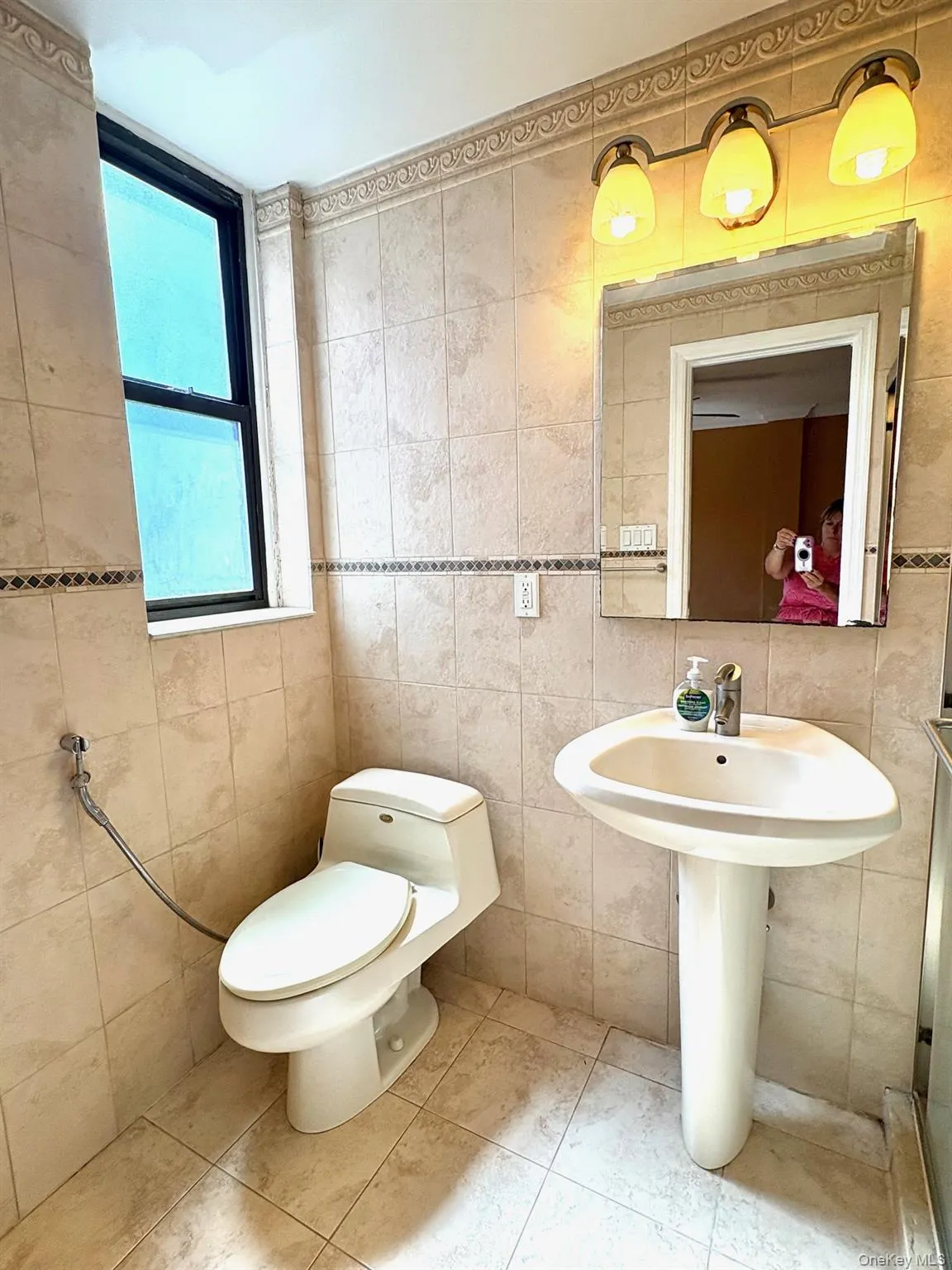 Half bathroom with tile walls and tile patterned floors Half bathroom with tile walls and tile patterned floors