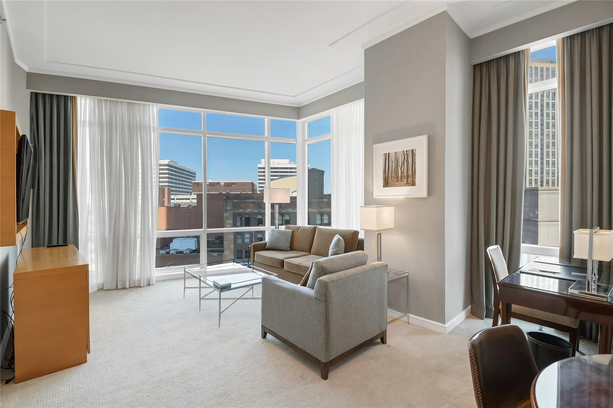 Living room with light carpet, ornamental molding, plenty of natural light, and baseboards Living room with light carpet, ornamental molding, plenty of natural light, and baseboards