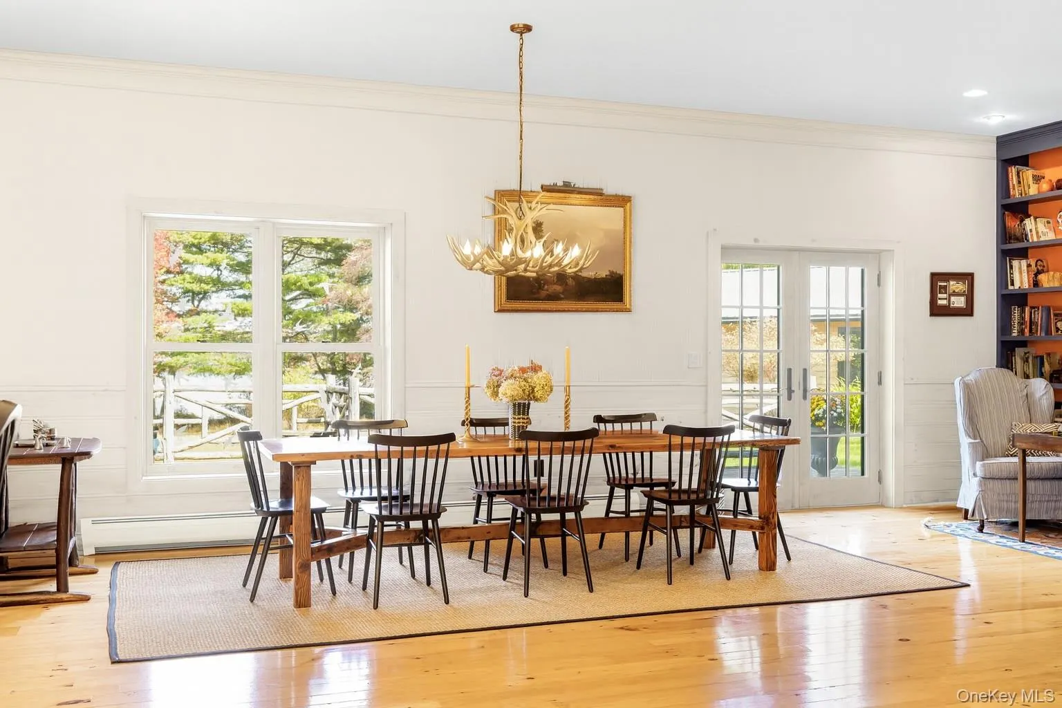 Dining room featuring light wood-style flooring, crown molding, and a chandelier Dining room featuring light wood-style flooring, crown molding, and a chandelier