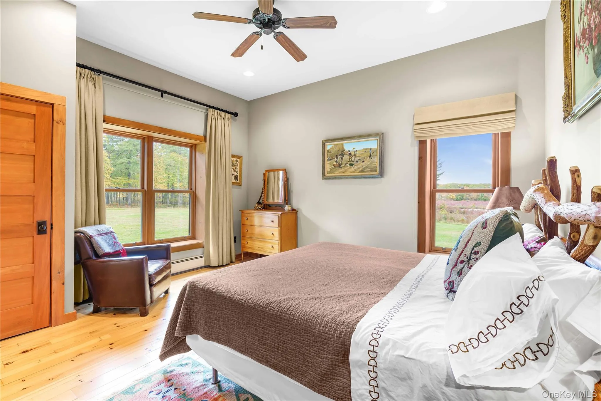 Bedroom featuring wood-type flooring, recessed lighting, a baseboard heating unit, and ceiling fan Bedroom featuring wood-type flooring, recessed lighting, a baseboard heating unit, and ceiling fan