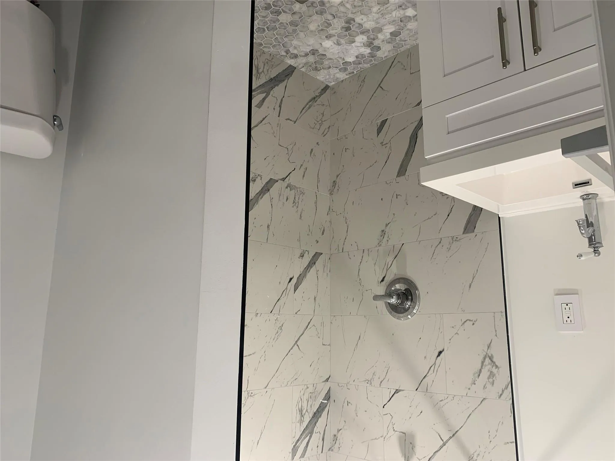 Bathroom featuring a shower stall, toilet, and vanity Bathroom featuring a shower stall, toilet, and vanity