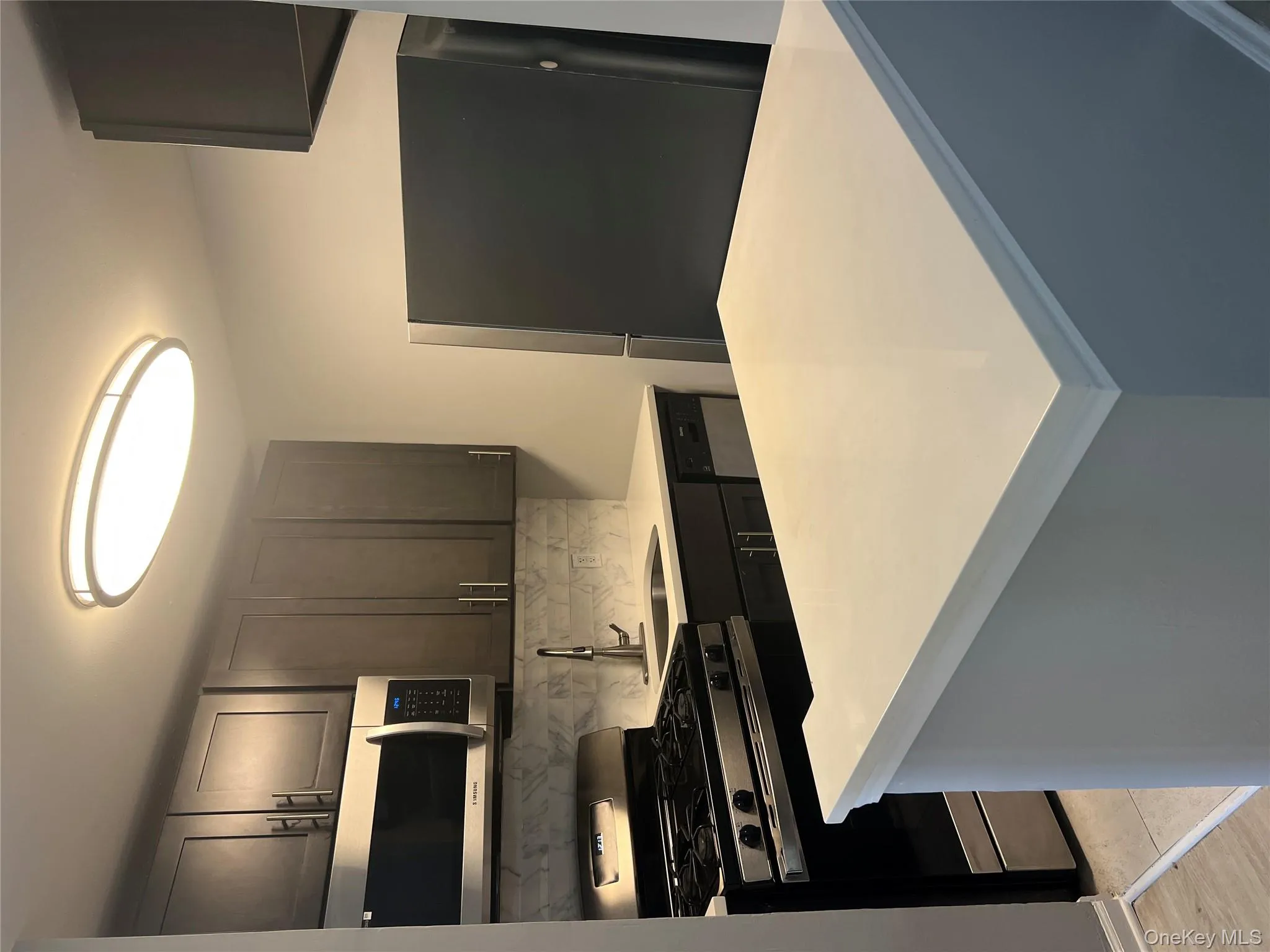 Kitchen with range, refrigerator, decorative backsplash, a sink, and dishwasher Kitchen with range, refrigerator, decorative backsplash, a sink, and dishwasher