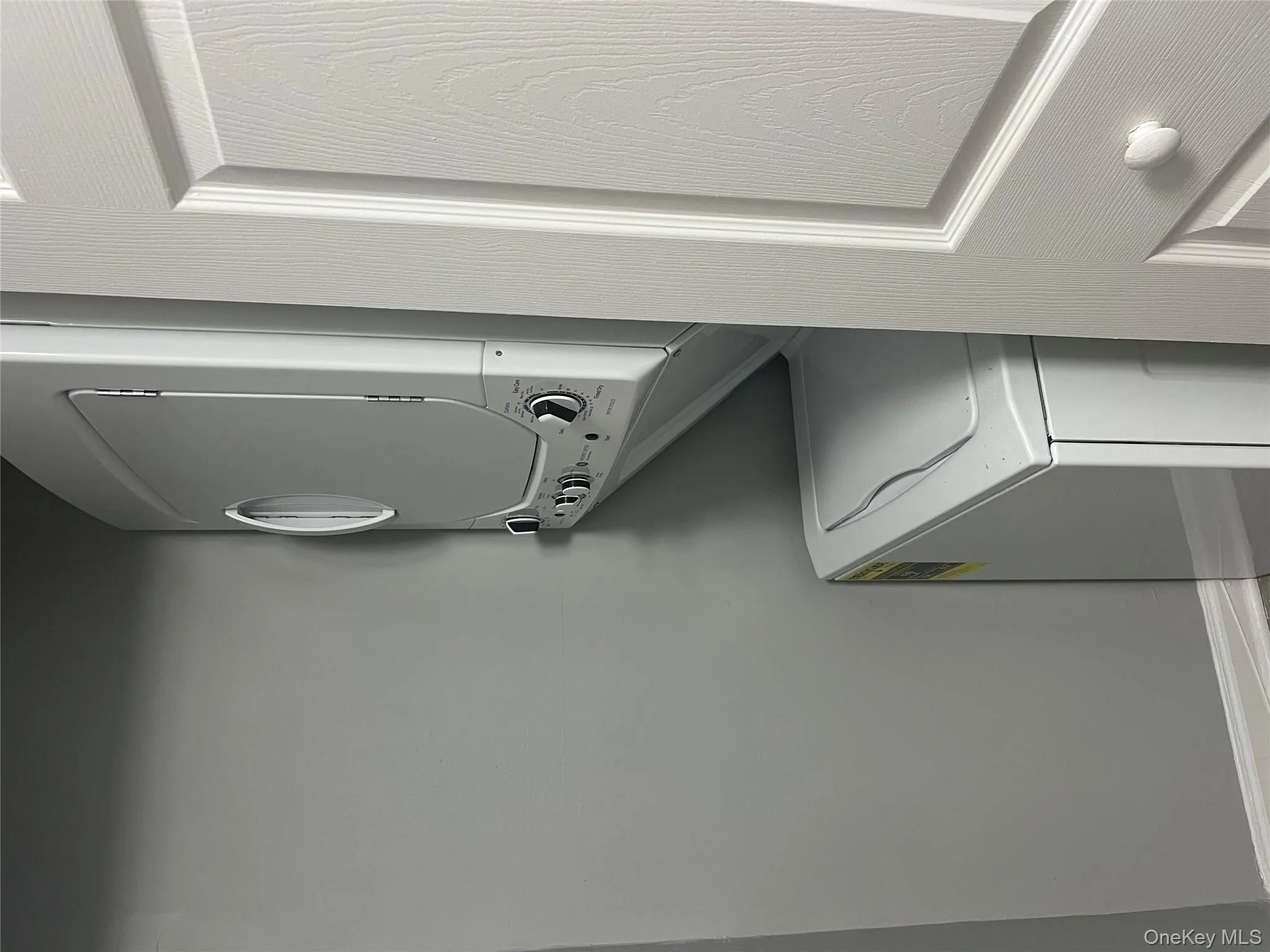 Laundry area with stacked washer and clothes dryer Laundry area with stacked washer and clothes dryer