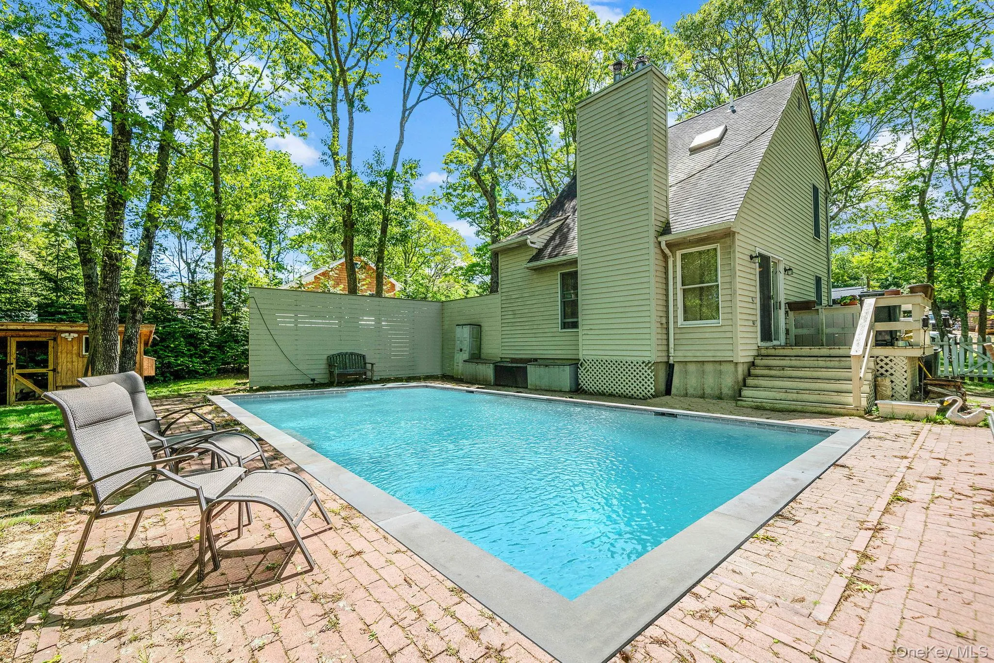 View of swimming pool with a deck and a patio area View of swimming pool with a deck and a patio area