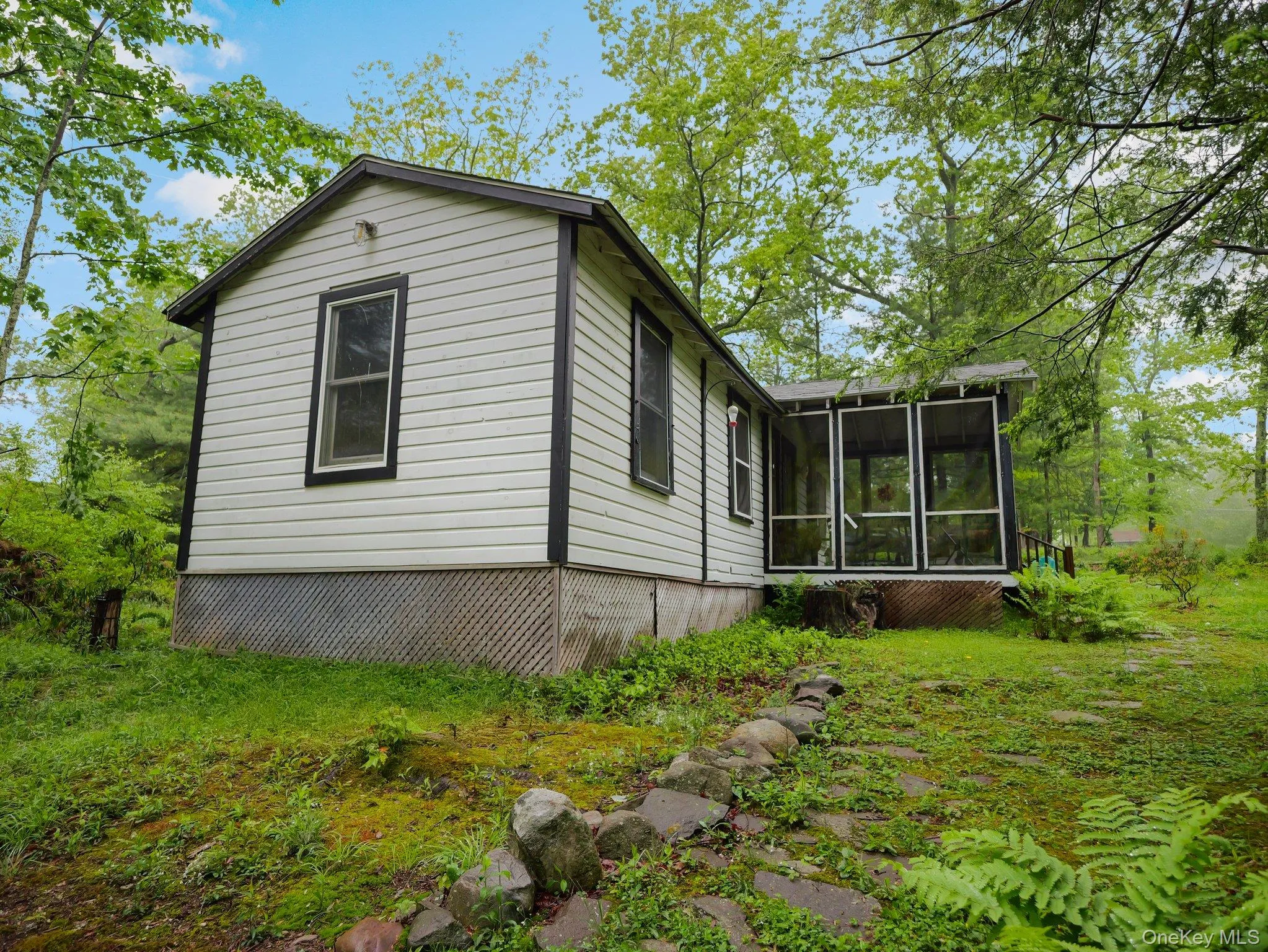 View of side of home with a sunroom View of side of home with a sunroom