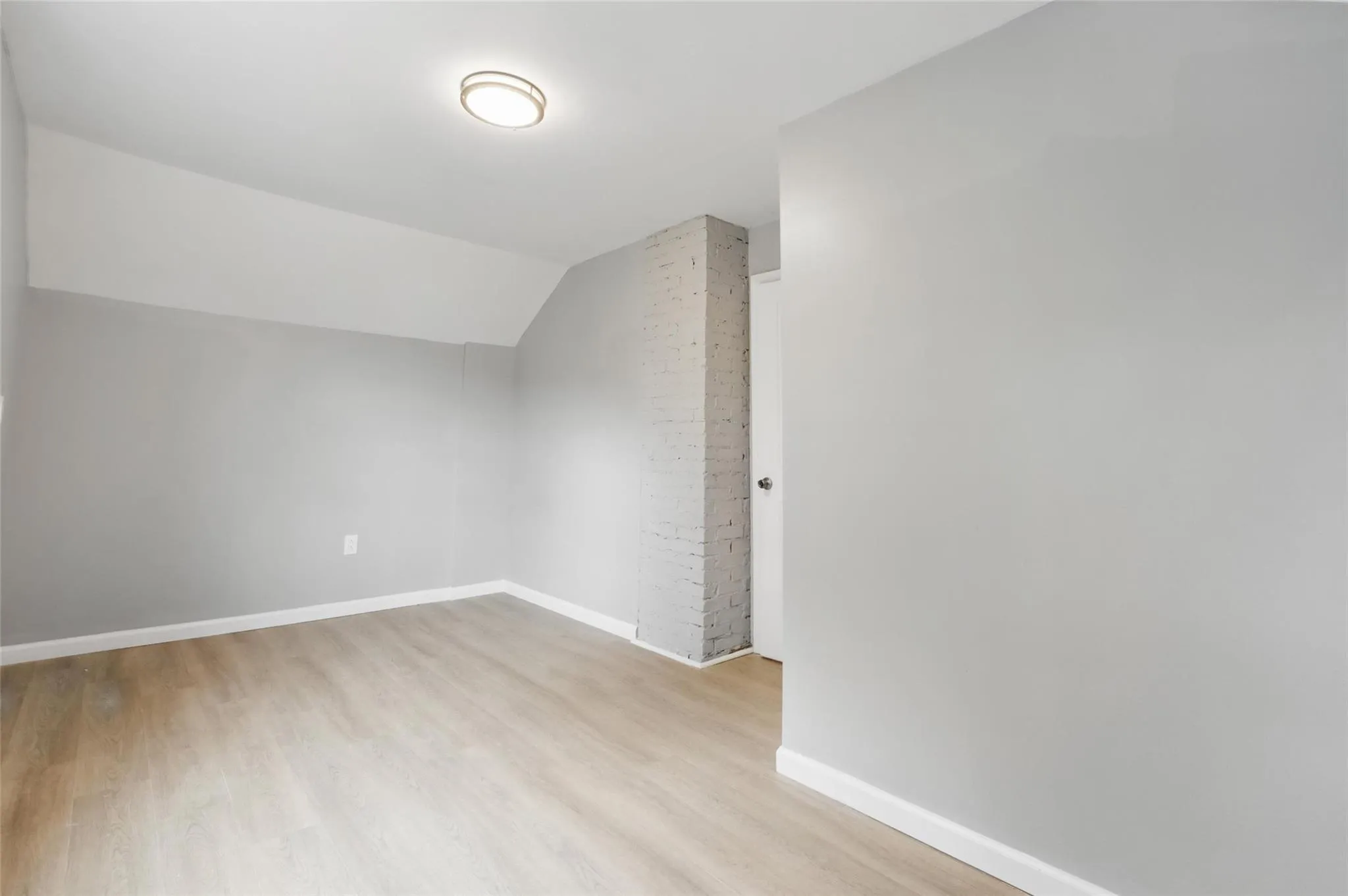 Additional living space featuring wood finished floors, baseboards, and vaulted ceiling Additional living space featuring wood finished floors, baseboards, and vaulted ceiling