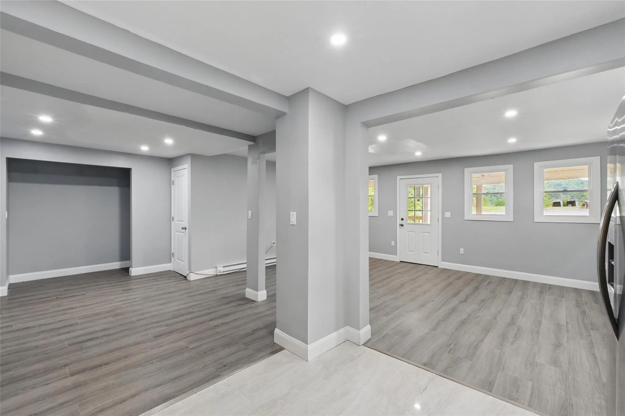 Basement featuring wood finished floors, recessed lighting, and baseboards Basement featuring wood finished floors, recessed lighting, and baseboards