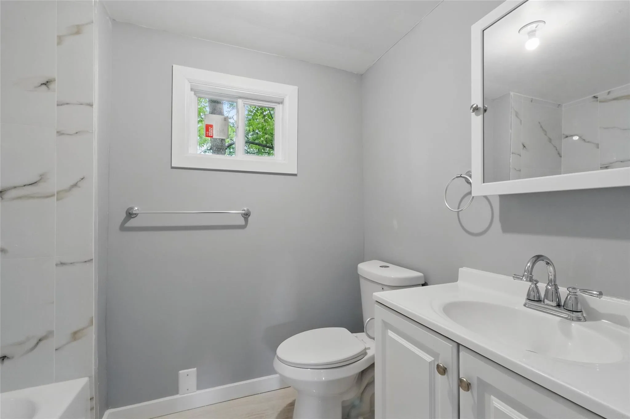 Full bathroom featuring vanity, toilet, and baseboards Full bathroom featuring vanity, toilet, and baseboards
