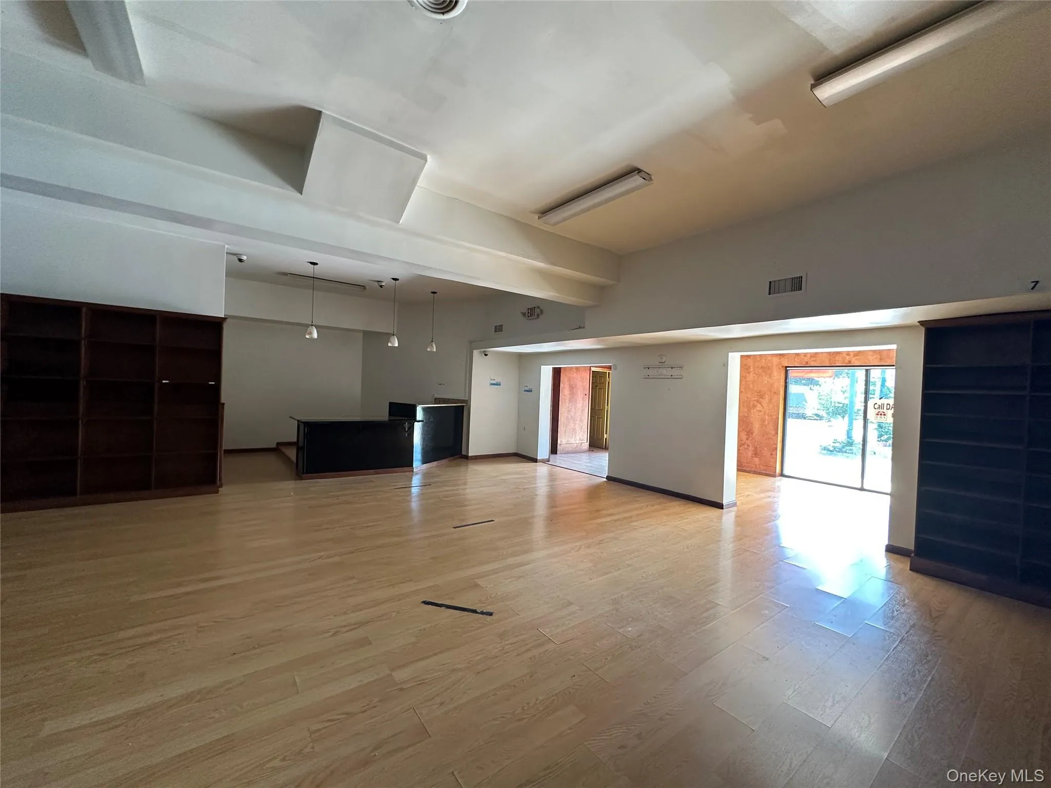 Unfurnished living room with wood finished floors and baseboards Unfurnished living room with wood finished floors and baseboards