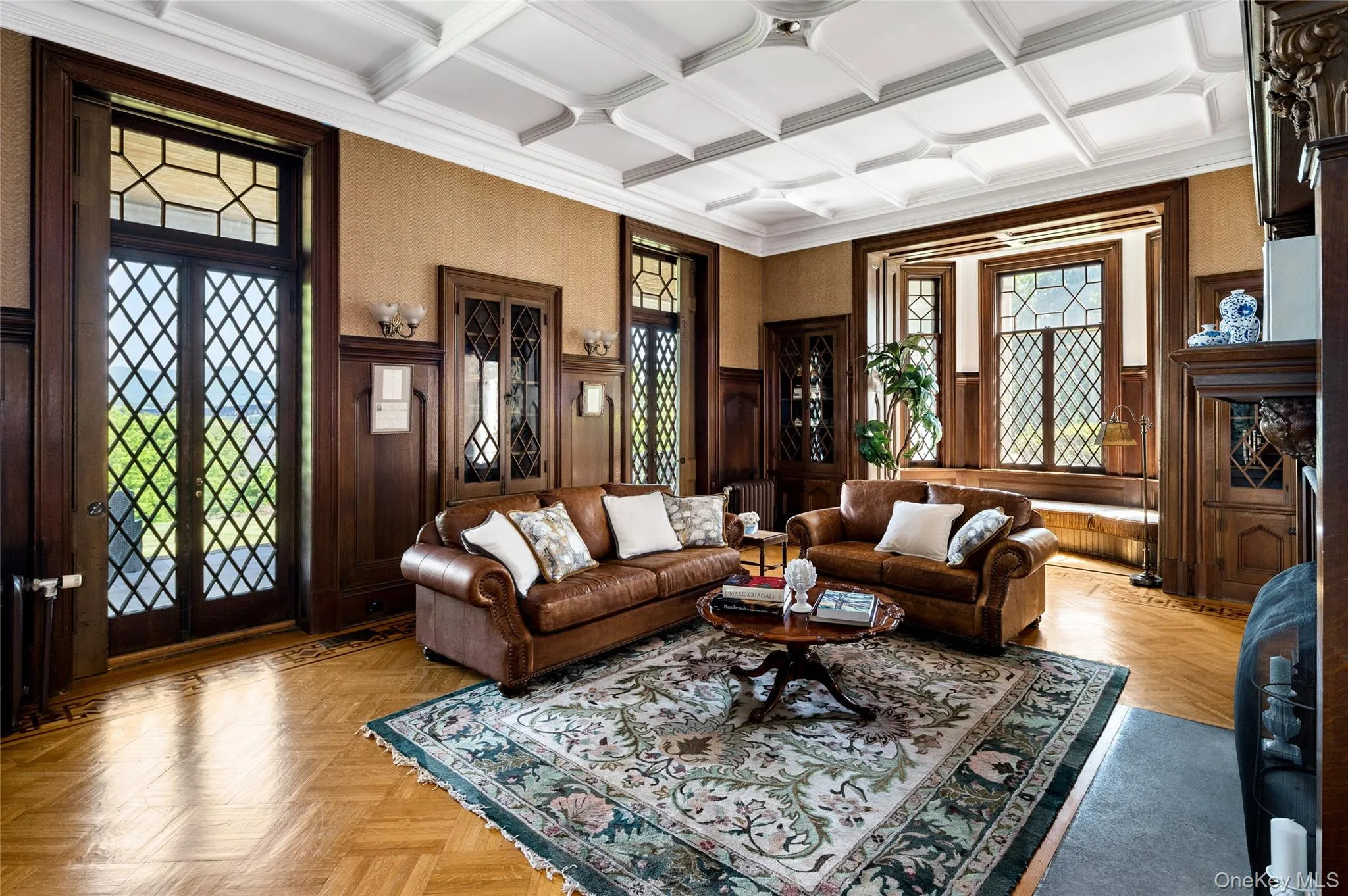 Built-ins, mullioned bay windows, fireplace, diamond-patterned glass doors, veranda access, inlaid and parquet floors, tracery ceiling. Built-ins, mullioned bay windows, fireplace, diamond-patterned glass doors, veranda access, inlaid and parquet floors, tracery ceiling.
