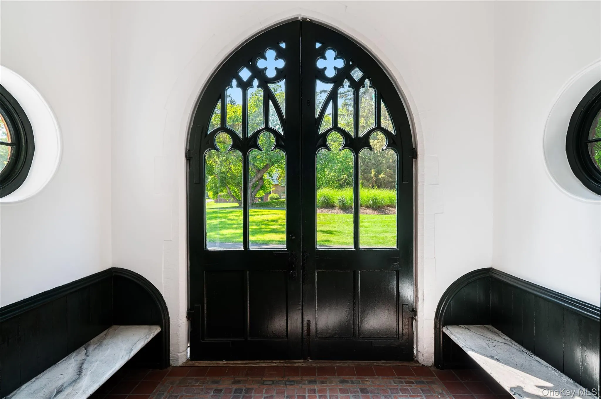 Arched double doors with pointed tracery in glass panels. Arched double doors with pointed tracery in glass panels.