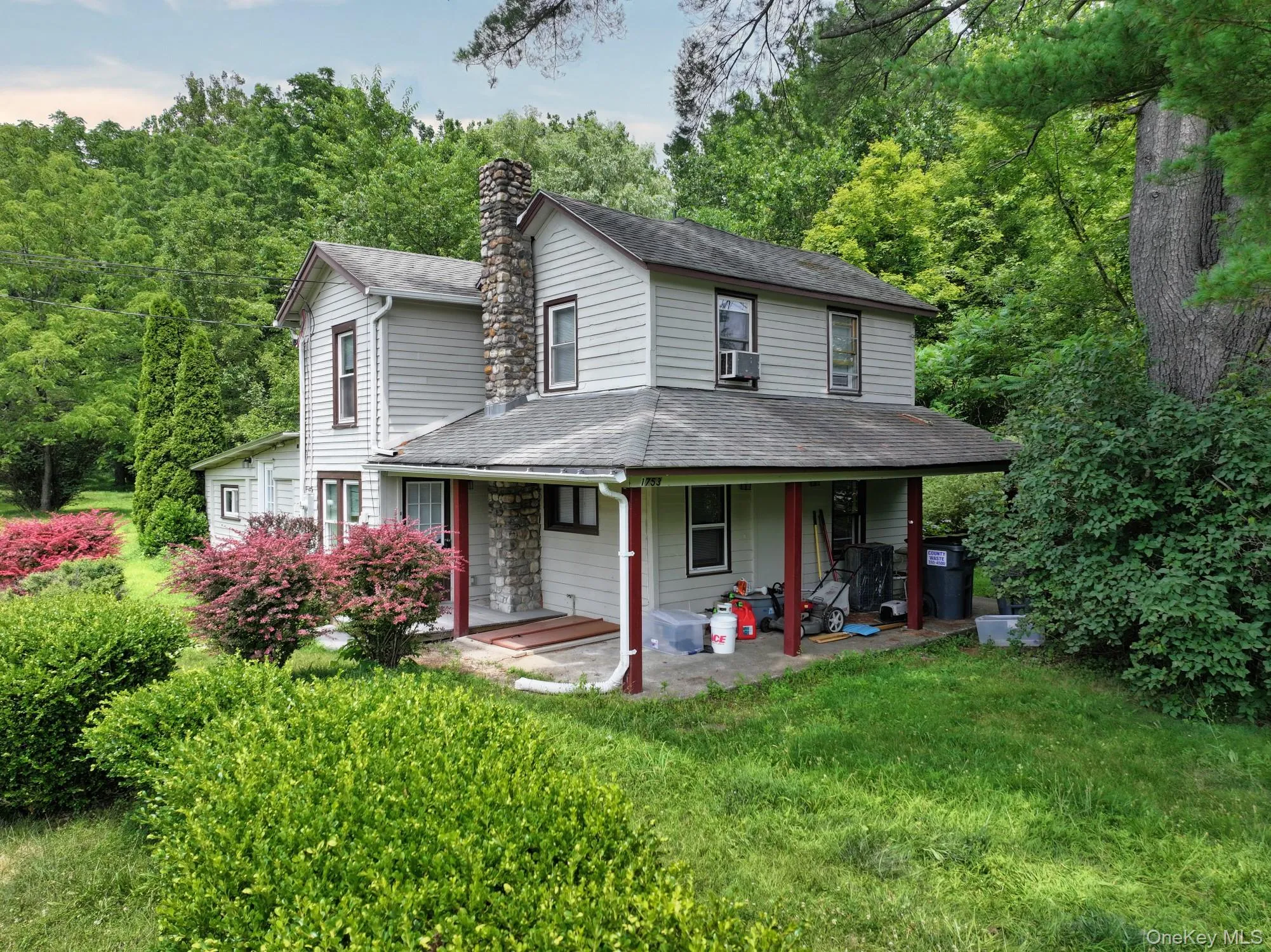 Back of property with a shingled roof, a chimney, a lawn, and cooling unit Back of property with a shingled roof, a chimney, a lawn, and cooling unit