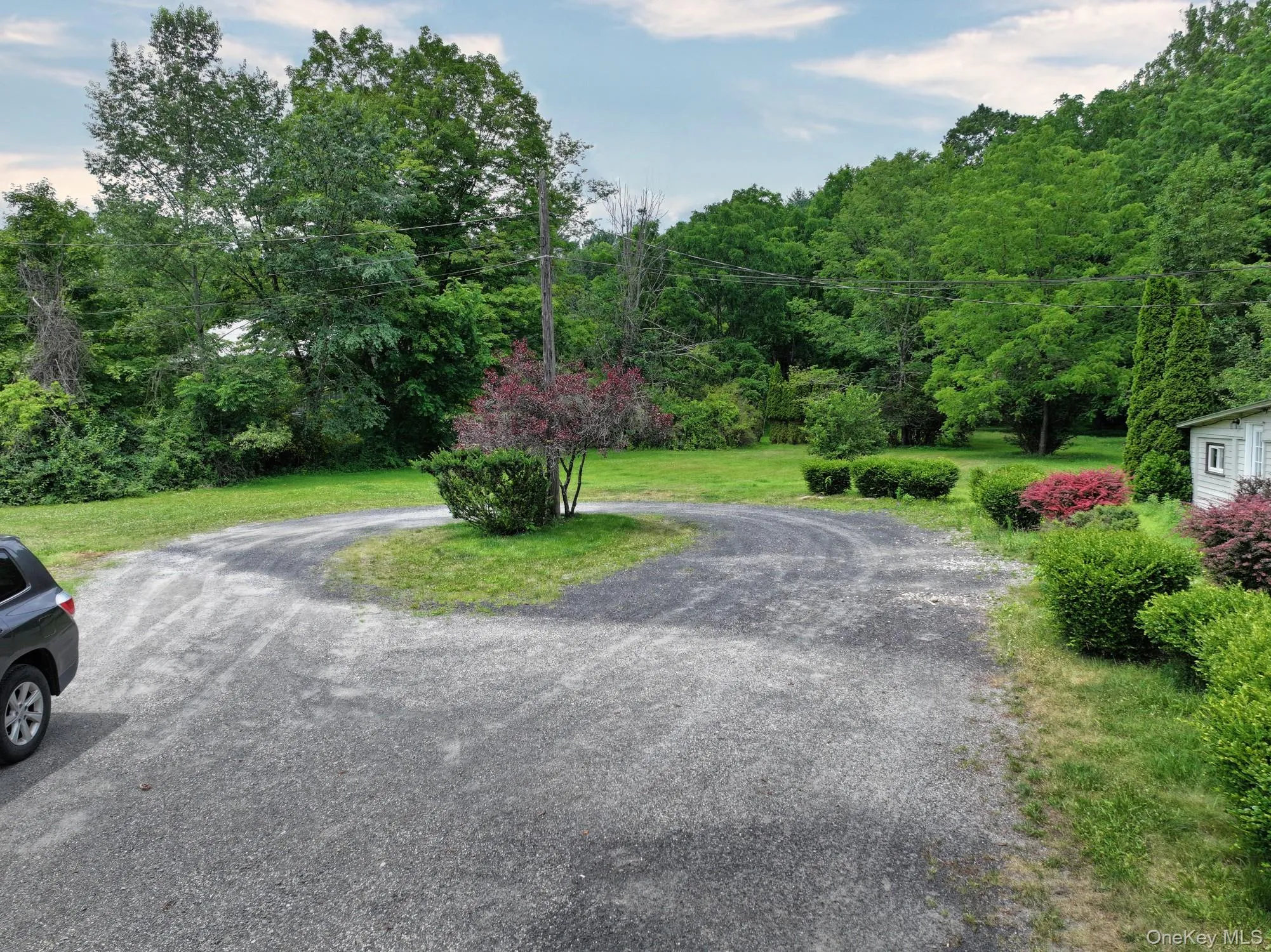 View of asphalt road featuring a wooded view View of asphalt road featuring a wooded view