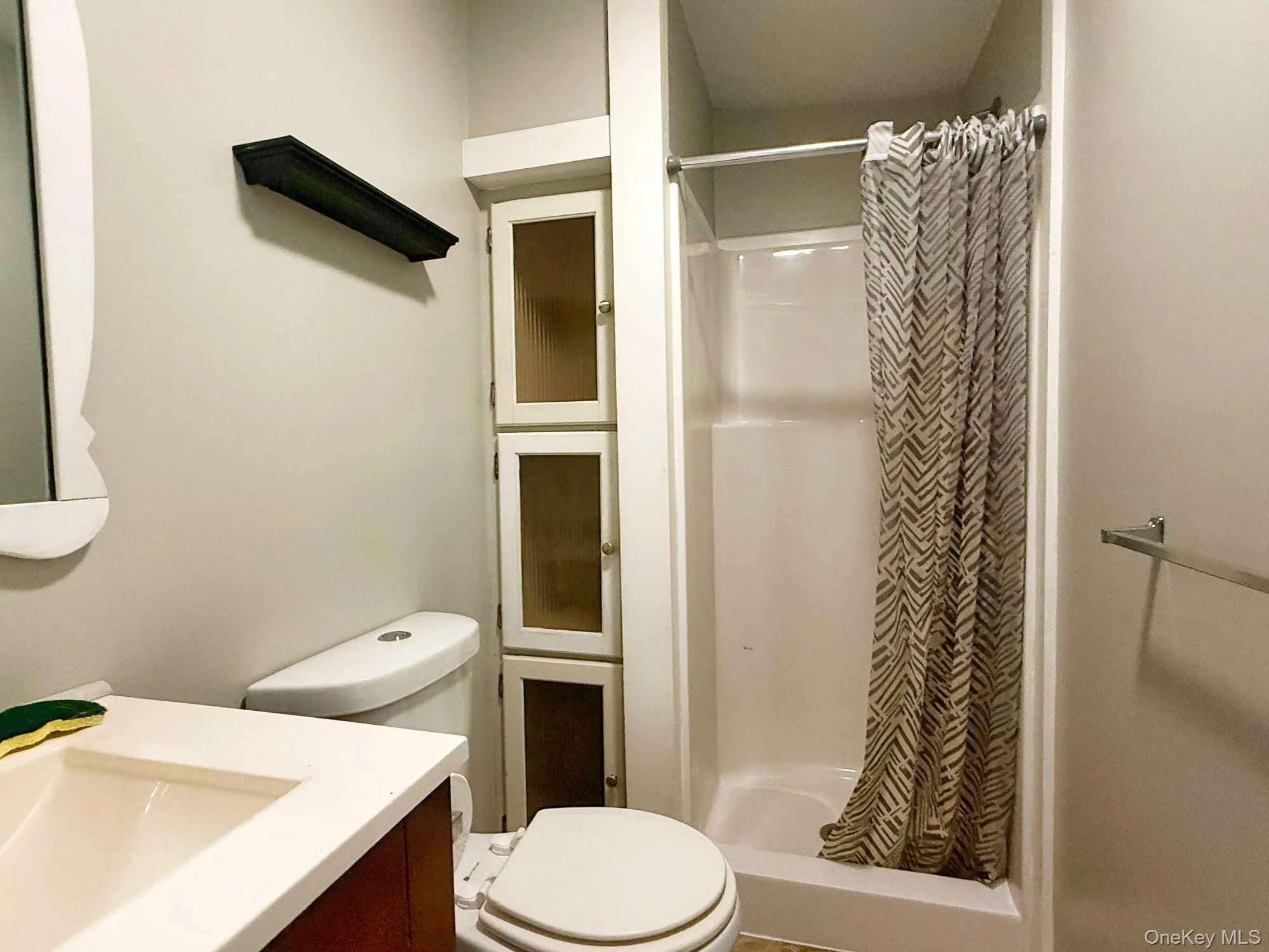 Bathroom with a shower stall and vanity Bathroom with a shower stall and vanity
