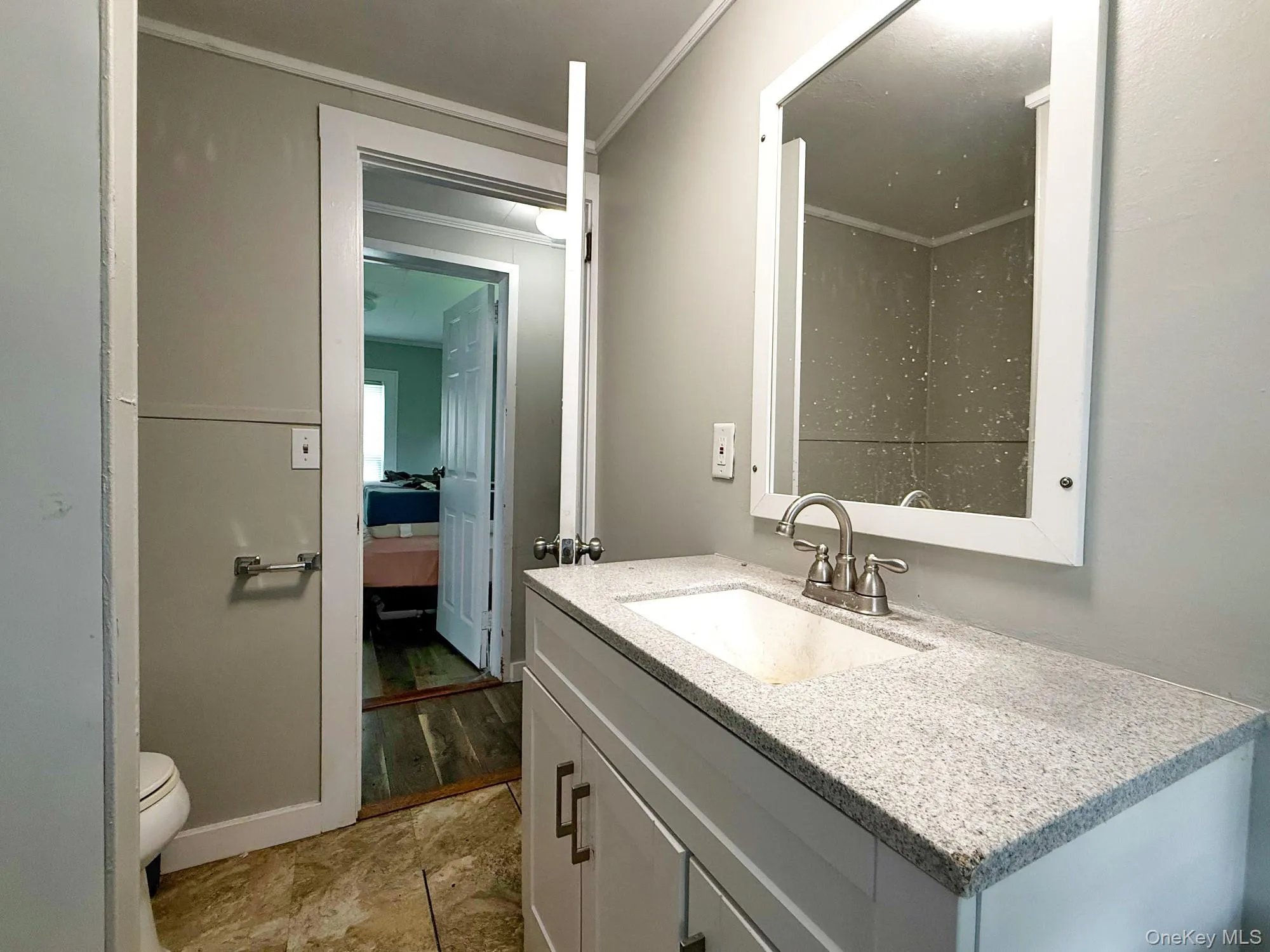Bathroom featuring vanity and ornamental molding Bathroom featuring vanity and ornamental molding