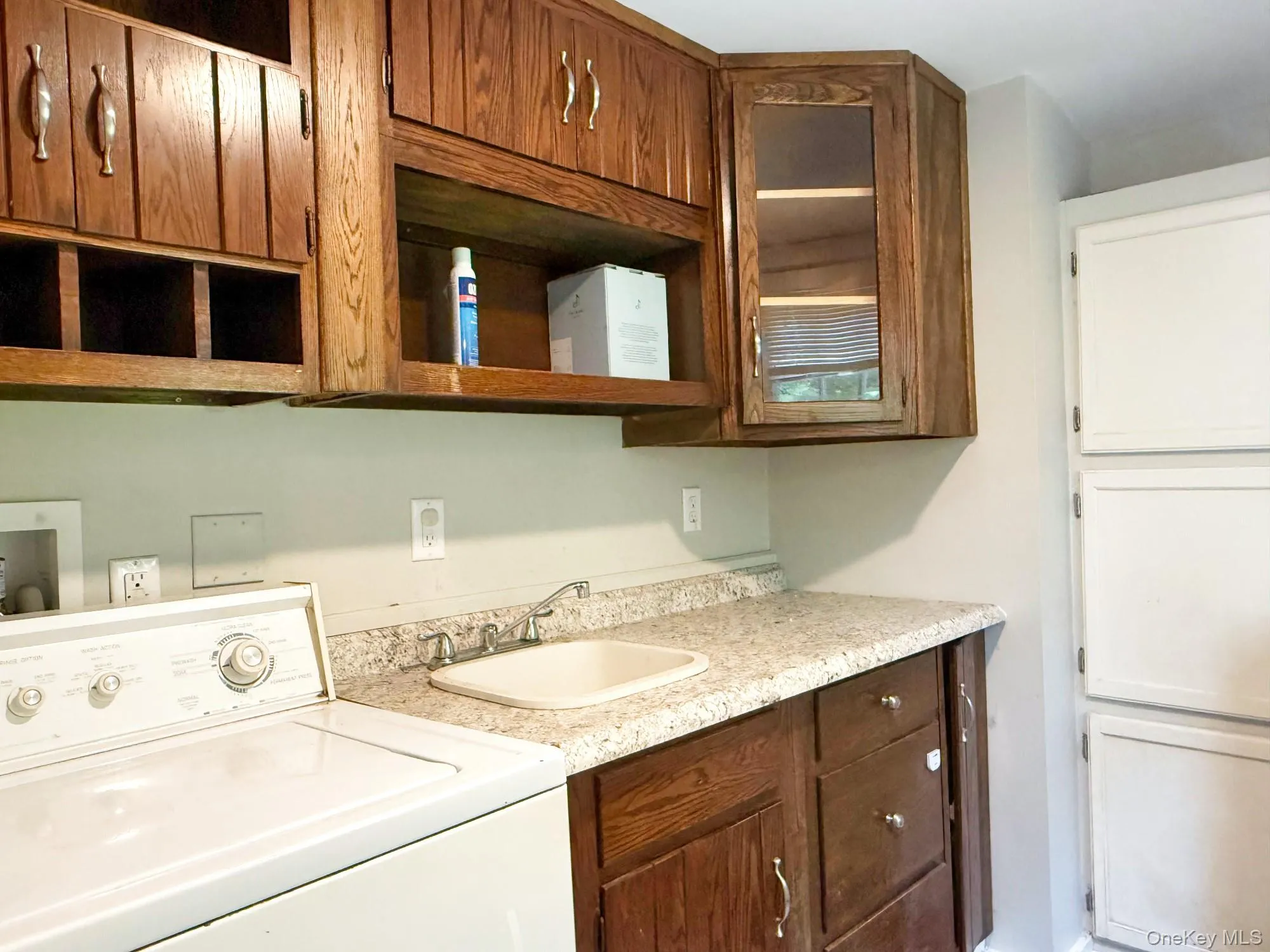 Laundry area featuring washer / clothes dryer and cabinet space Laundry area featuring washer / clothes dryer and cabinet space