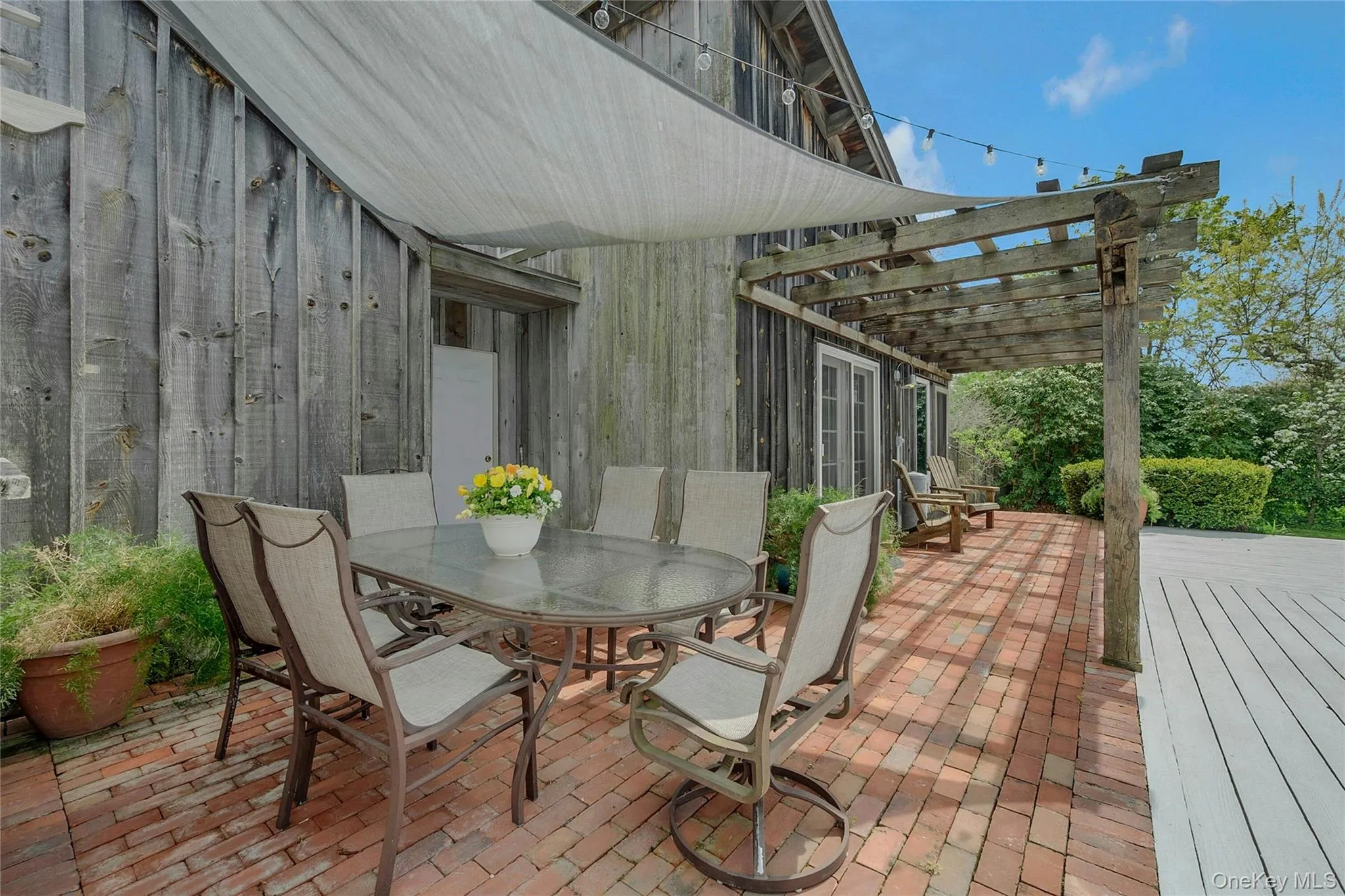 View of patio / terrace with a pergola and outdoor dining area View of patio / terrace with a pergola and outdoor dining area