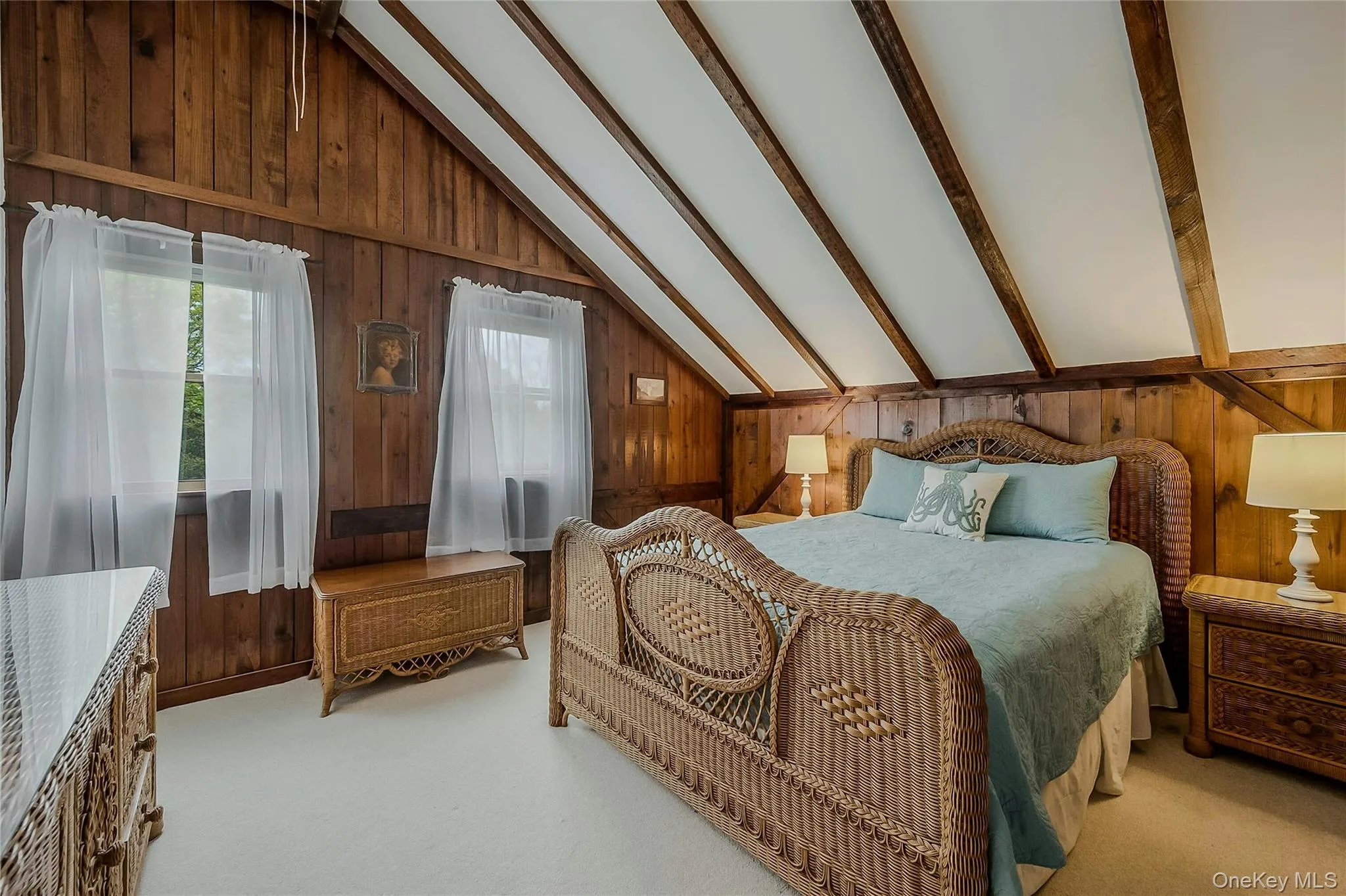 Bedroom featuring wood walls and light carpet Bedroom featuring wood walls and light carpet