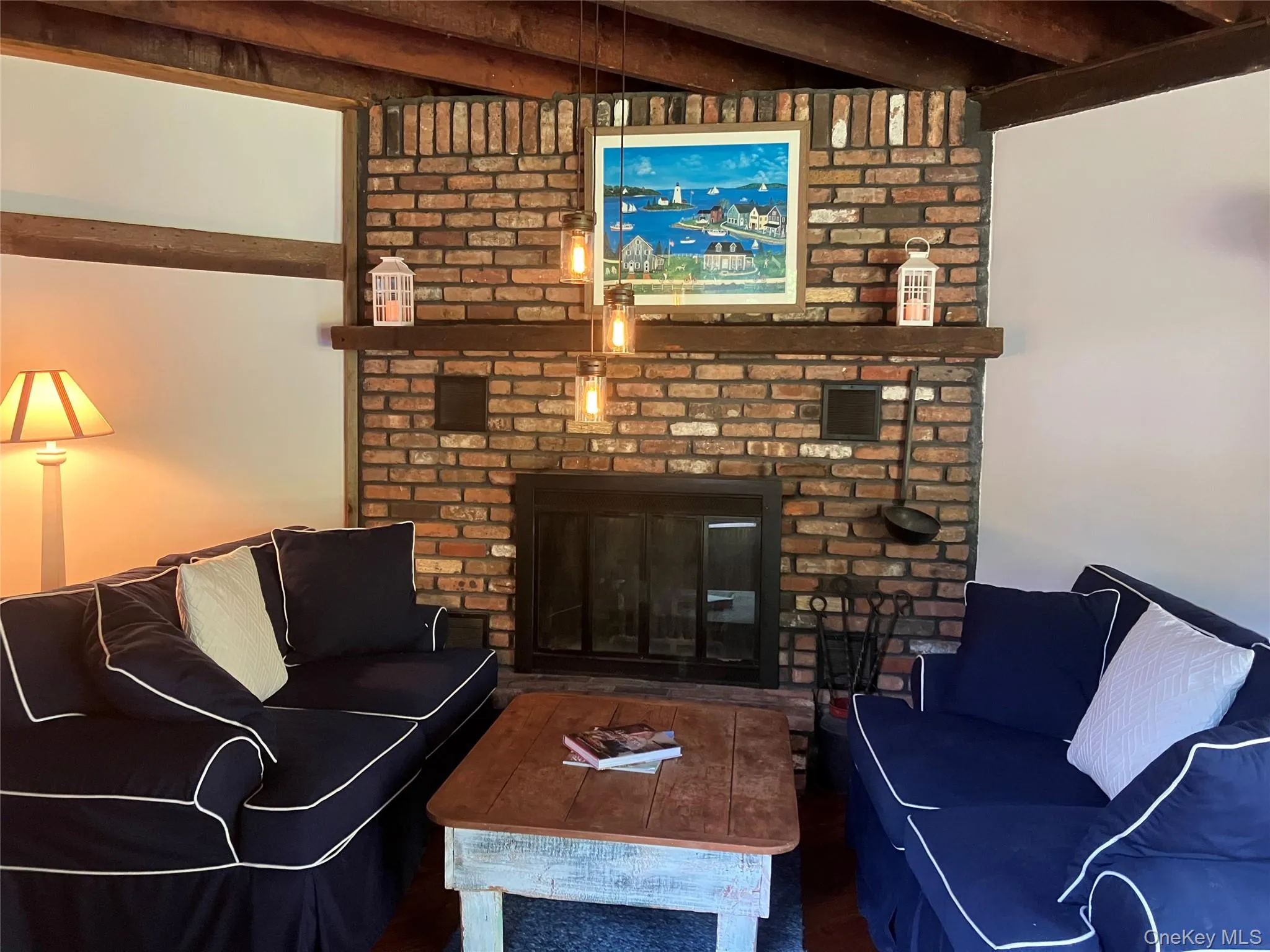 Living area with a brick fireplace and beamed ceiling Living area with a brick fireplace and beamed ceiling