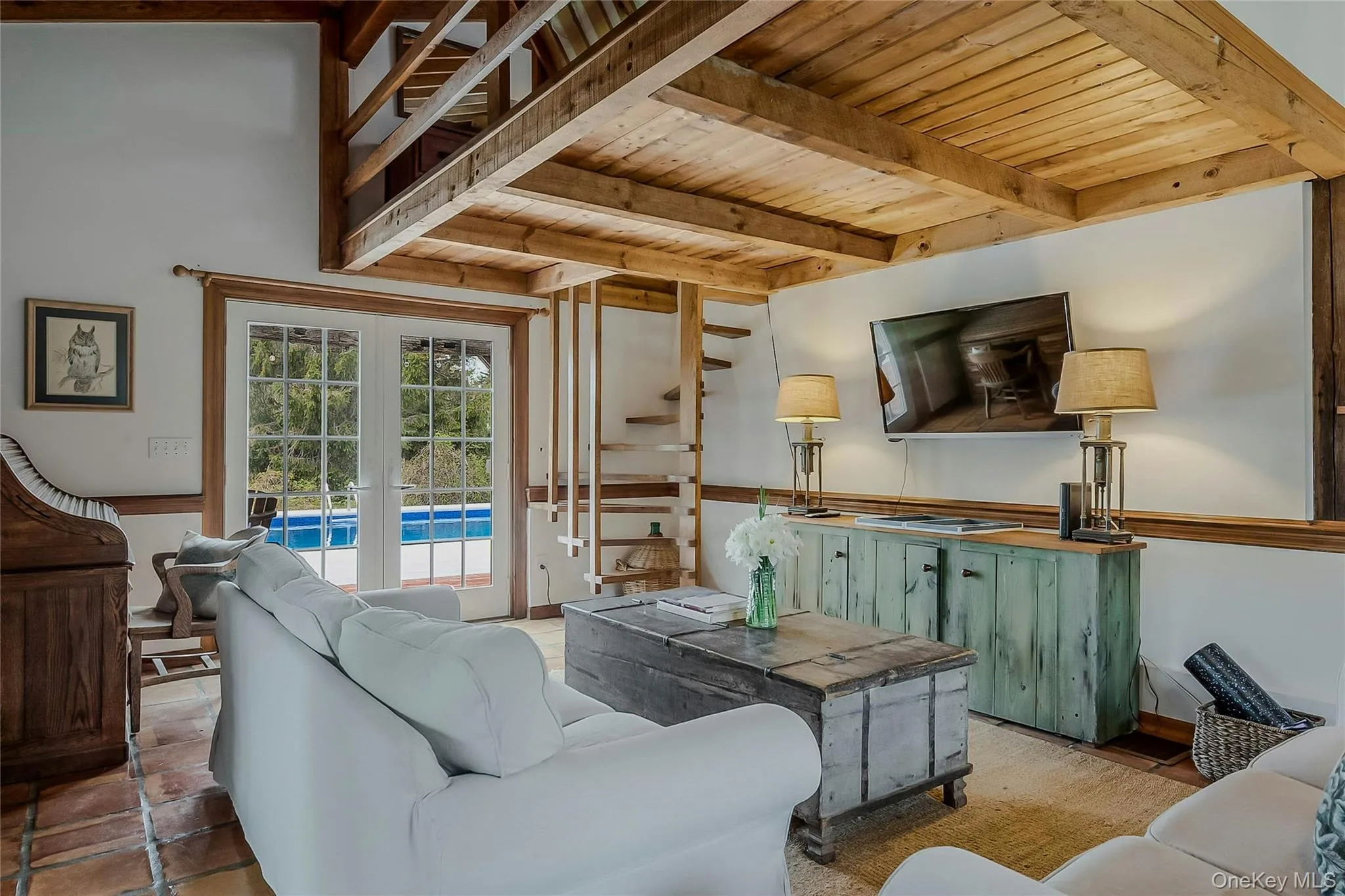 Living area with wooden ceiling with exposed beams and french doors Living area with wooden ceiling with exposed beams and french doors
