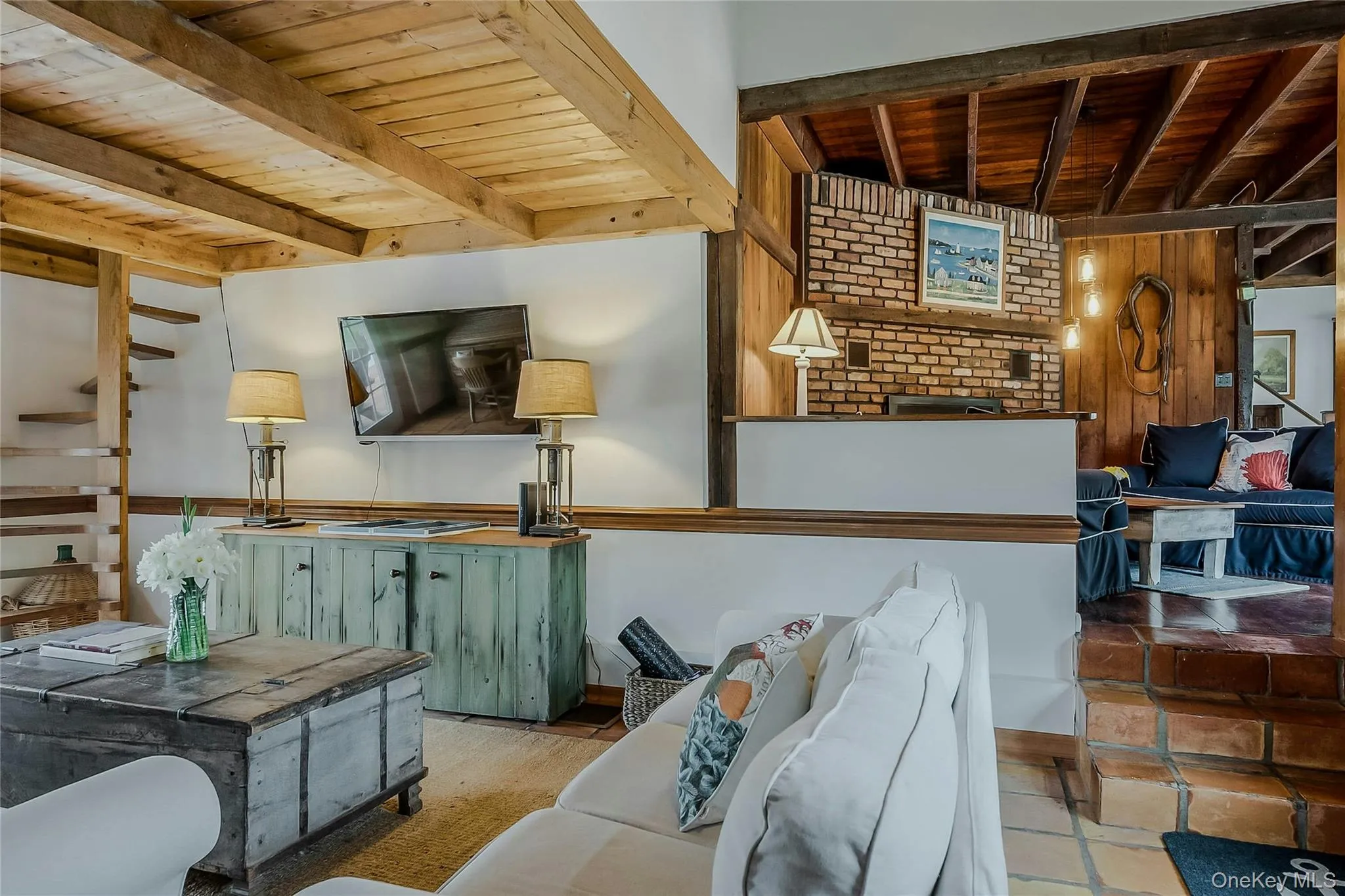 Living area featuring wooden ceiling with exposed beams Living area featuring wooden ceiling with exposed beams
