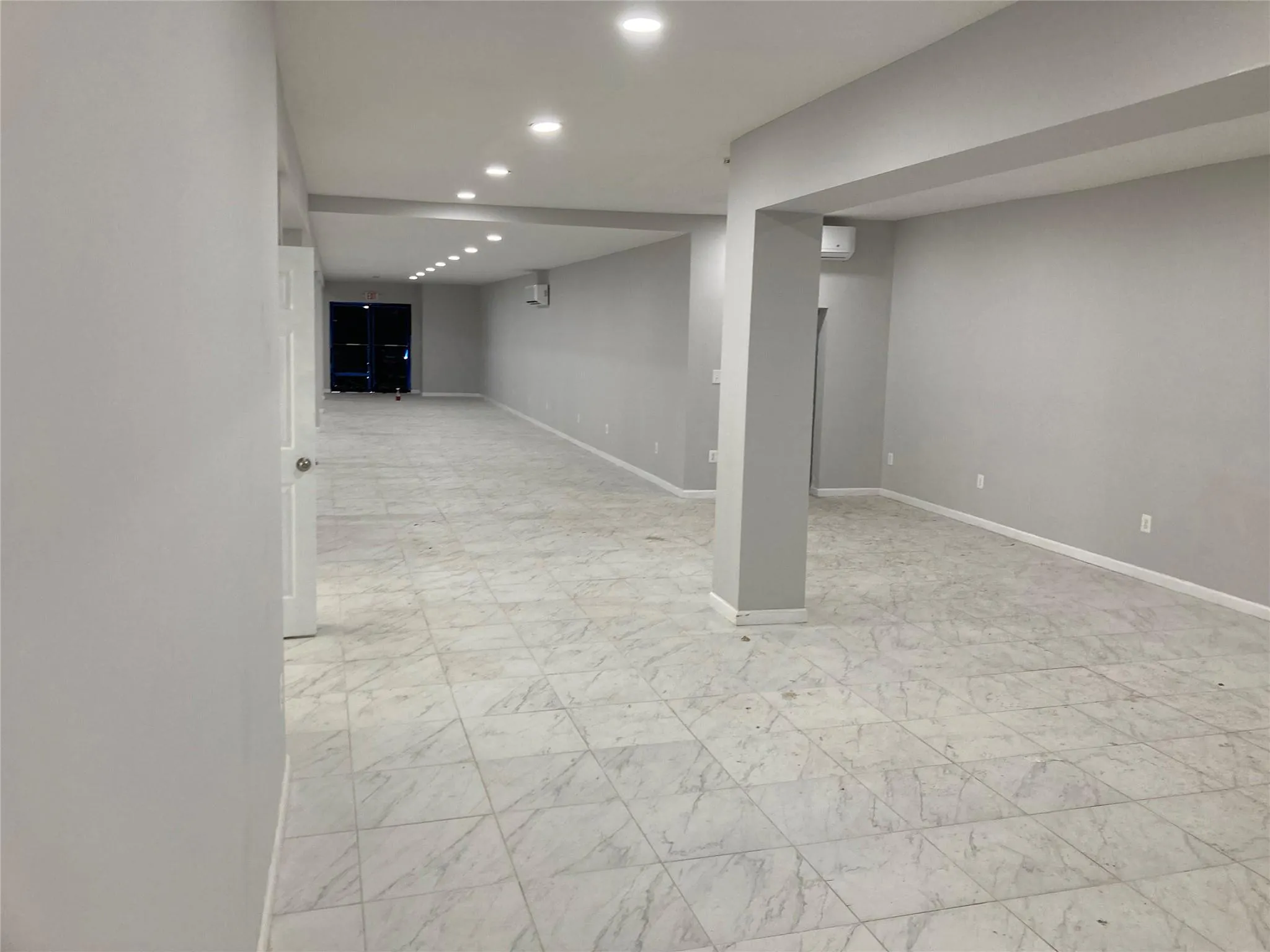 Finished basement with recessed lighting, baseboards, and light marble finish flooring Finished basement with recessed lighting, baseboards, and light marble finish flooring