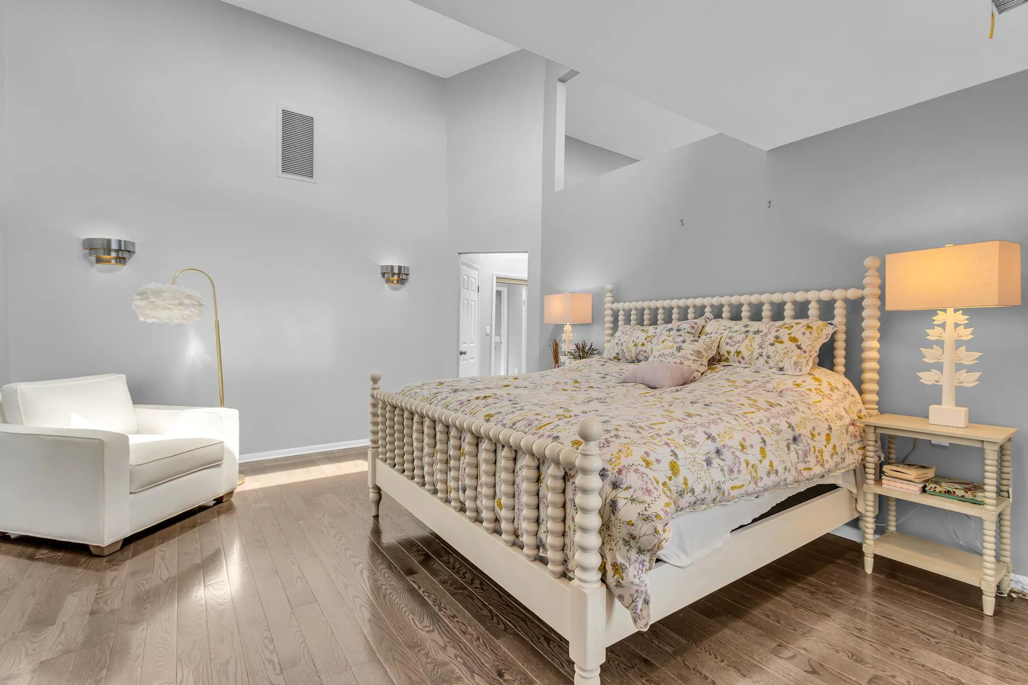 Bedroom with baseboards, wood finished floors, and a high ceiling Bedroom with baseboards, wood finished floors, and a high ceiling