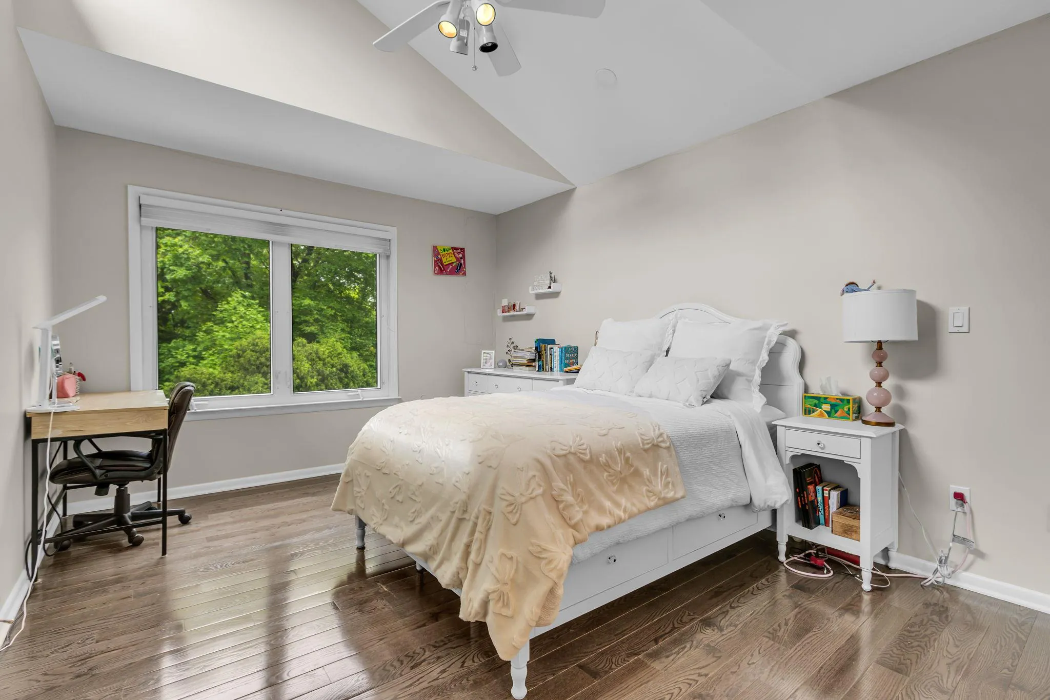 Bedroom with lofted ceiling, wood finished floors, baseboards, ceiling fan, and a desk Bedroom with lofted ceiling, wood finished floors, baseboards, ceiling fan, and a desk