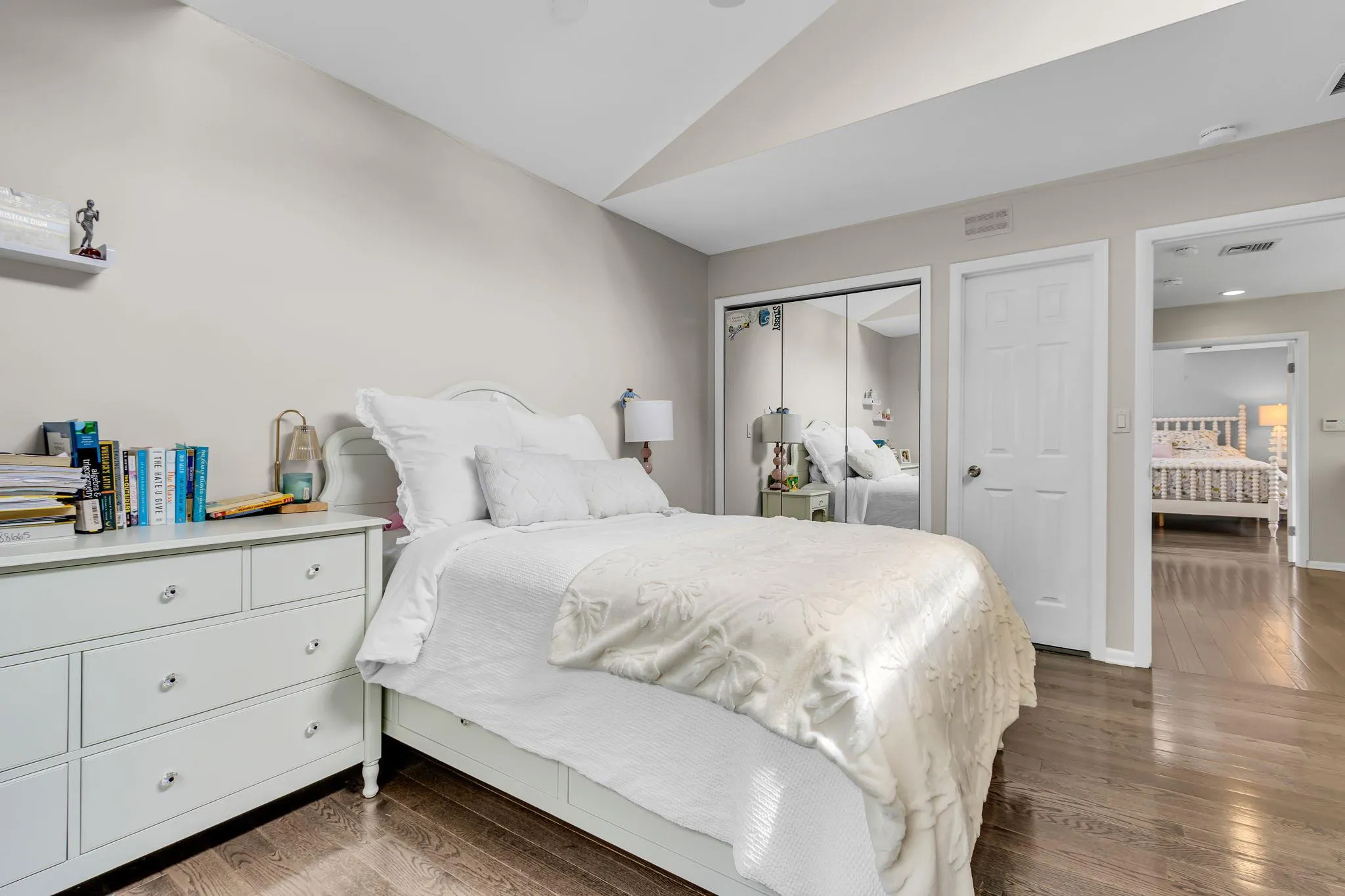 Bedroom with lofted ceiling, dark wood finished floors, a closet, and baseboards Bedroom with lofted ceiling, dark wood finished floors, a closet, and baseboards