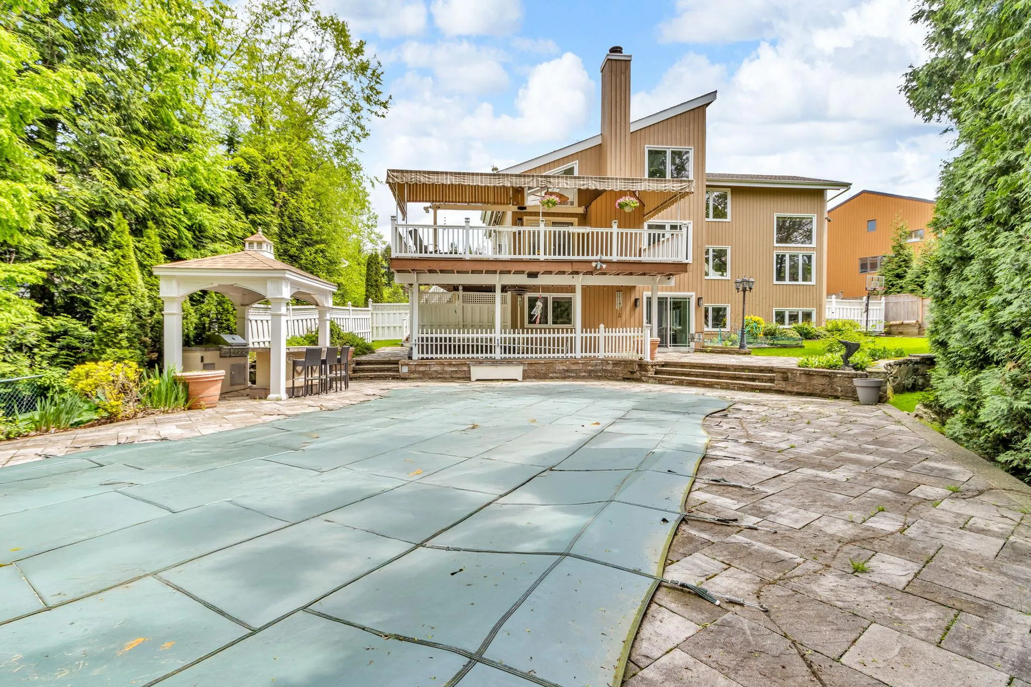 Back of property with a chimney, a covered pool, a gazebo, and a patio Back of property with a chimney, a covered pool, a gazebo, and a patio