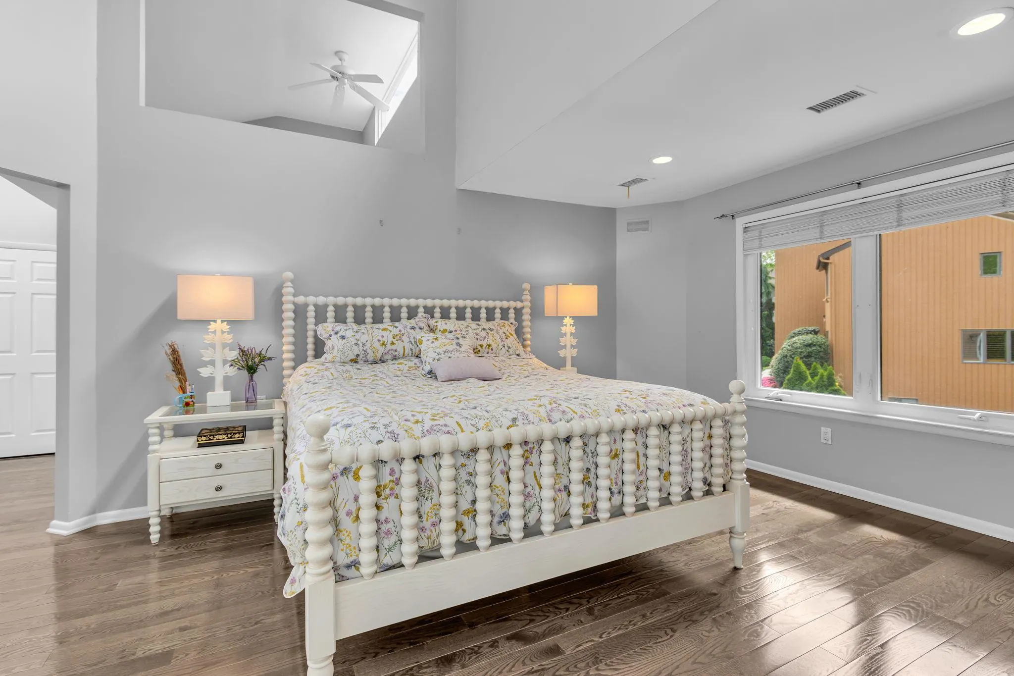 Bedroom featuring wood finished floors, baseboards, recessed lighting, and vaulted ceiling Bedroom featuring wood finished floors, baseboards, recessed lighting, and vaulted ceiling