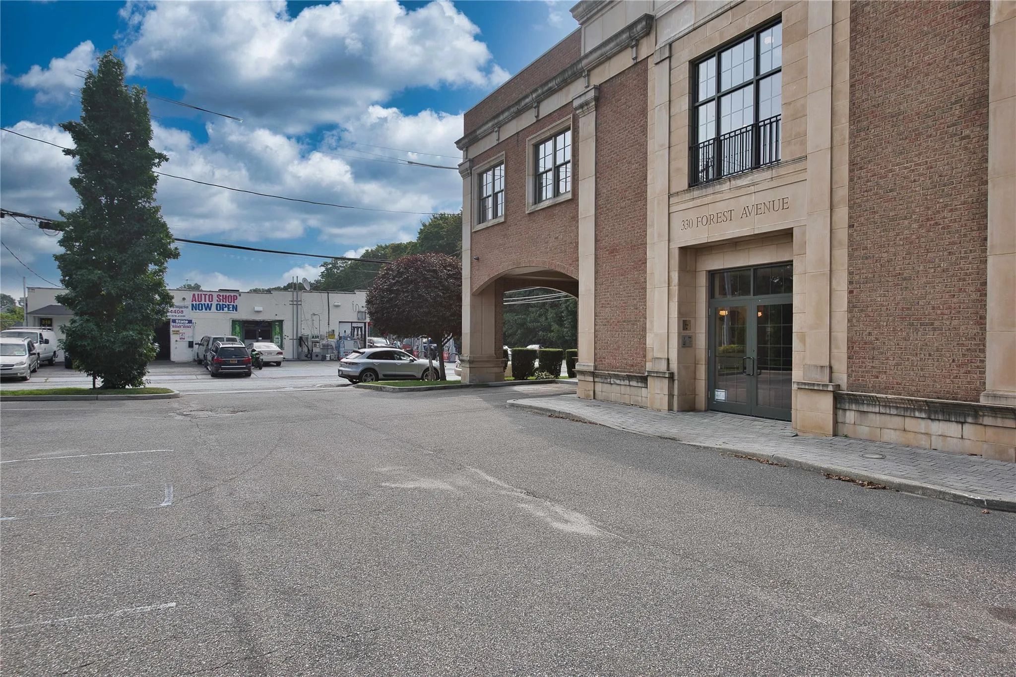 View of asphalt road with sidewalks, curbs, and street lighting View of asphalt road with sidewalks, curbs, and street lighting