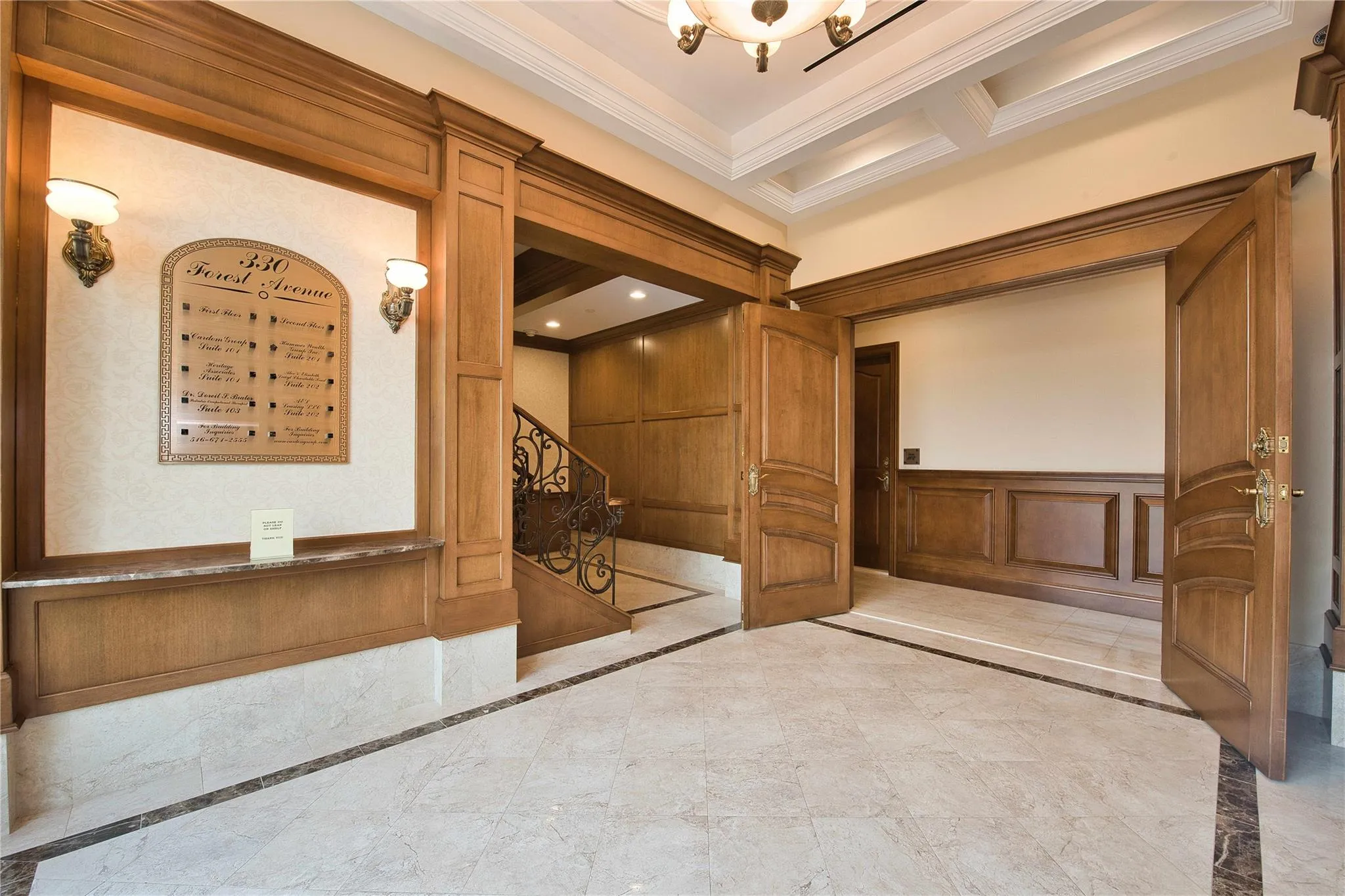 Hall with inlaid floor details, crown molding, a decorative wall, wainscoting, and beam ceiling Hall with inlaid floor details, crown molding, a decorative wall, wainscoting, and beam ceiling