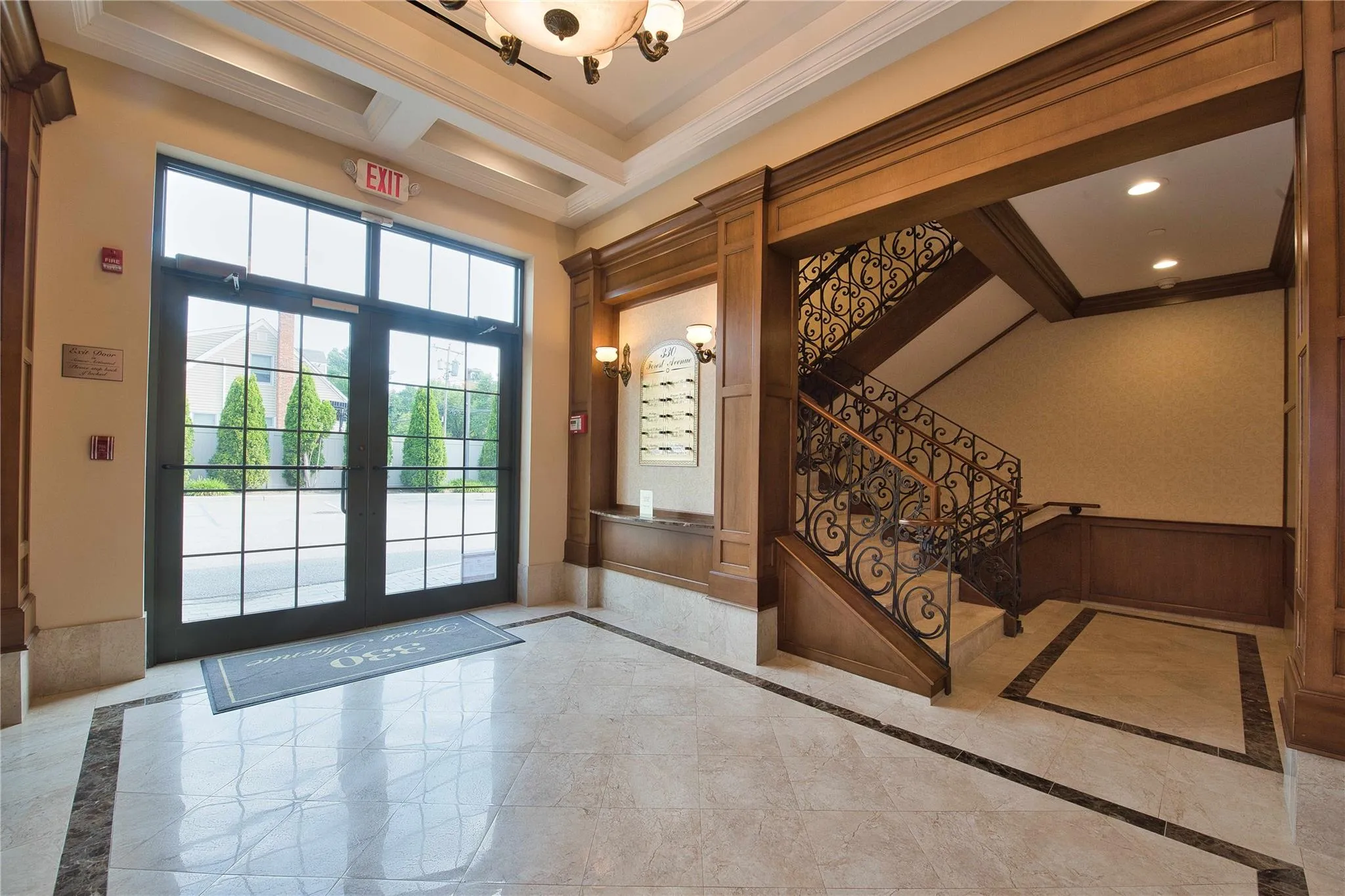 Entryway with inlaid floor details, crown molding, stairway, french doors, and beamed ceiling Entryway with inlaid floor details, crown molding, stairway, french doors, and beamed ceiling