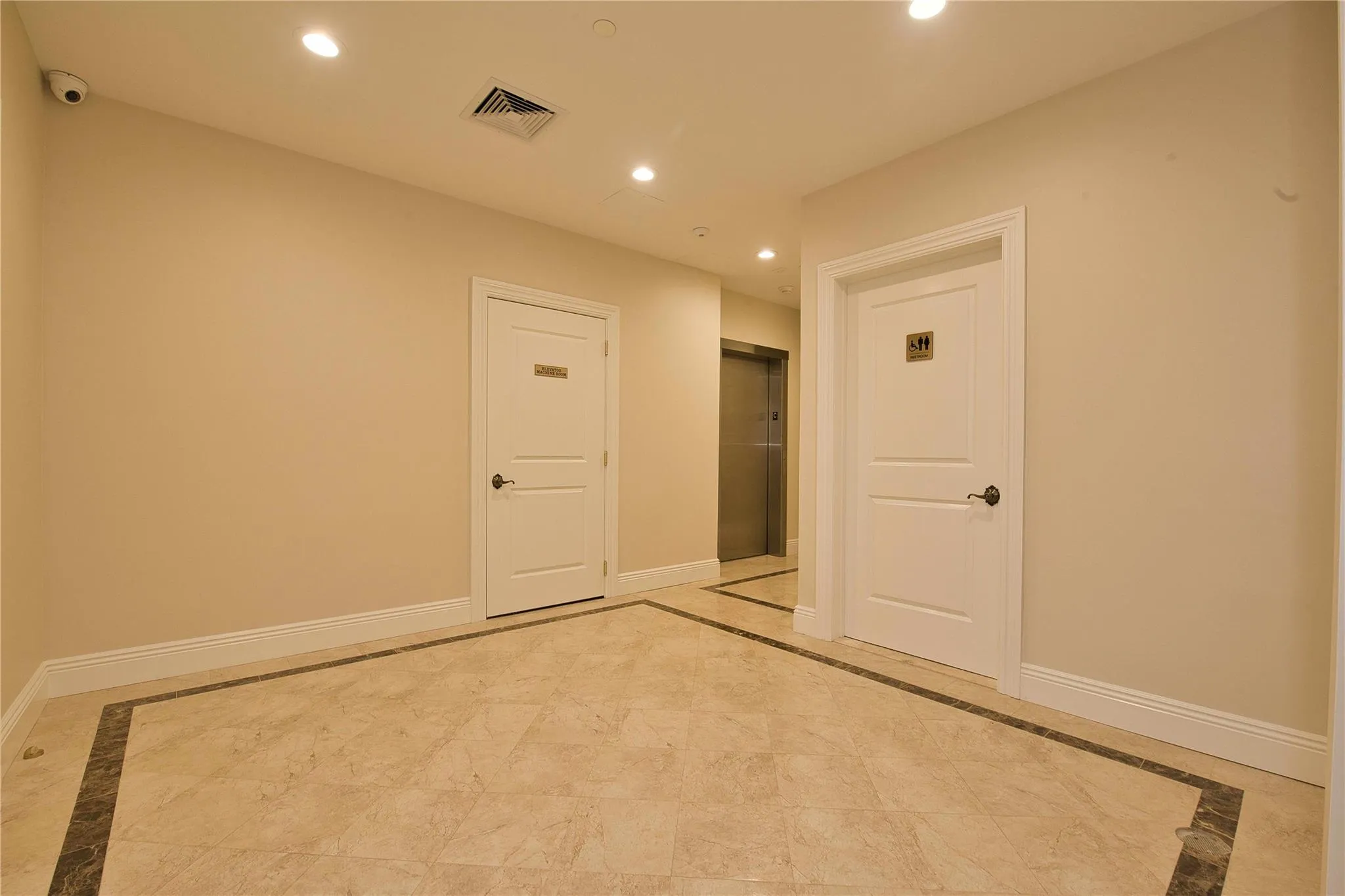 Unfurnished room with inlaid floor details, recessed lighting, and baseboards Unfurnished room with inlaid floor details, recessed lighting, and baseboards