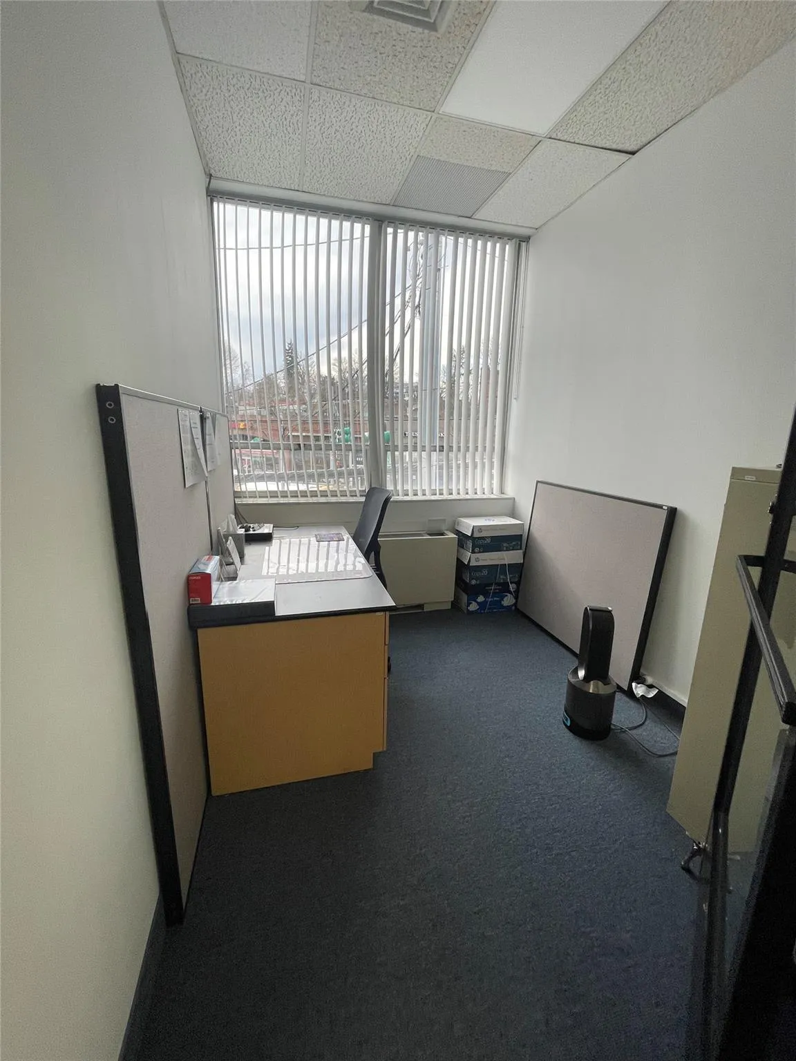 Unfurnished office with carpet flooring and a paneled ceiling Unfurnished office with carpet flooring and a paneled ceiling