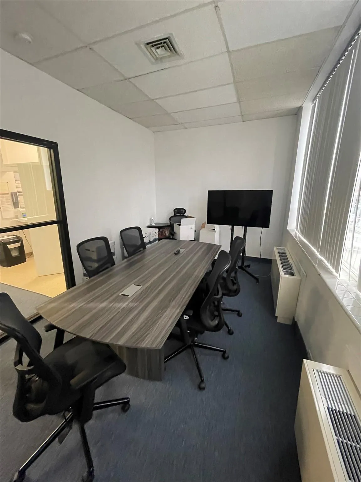 Office space featuring carpet floors and a paneled ceiling Office space featuring carpet floors and a paneled ceiling