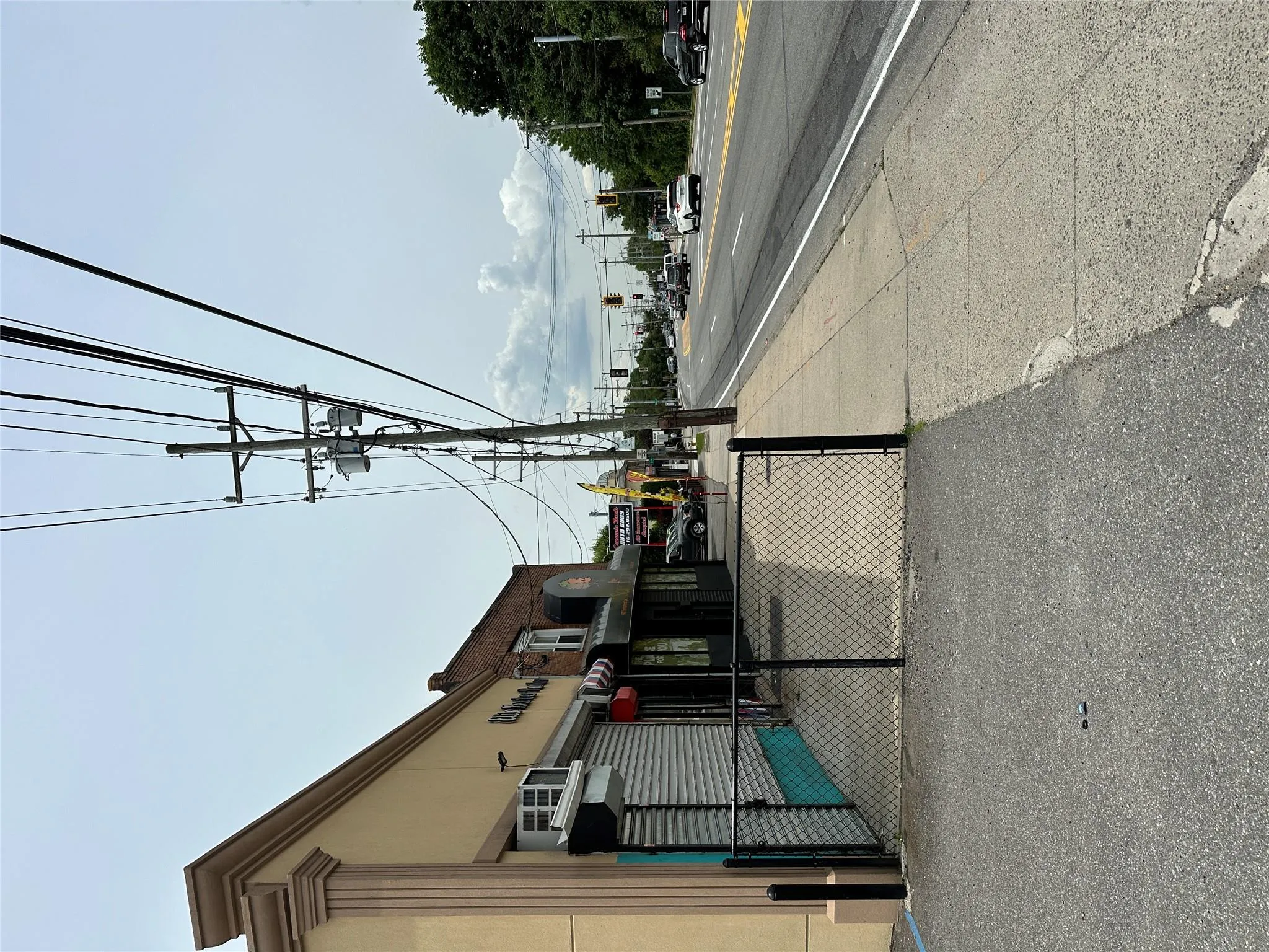 View of asphalt road featuring sidewalks View of asphalt road featuring sidewalks