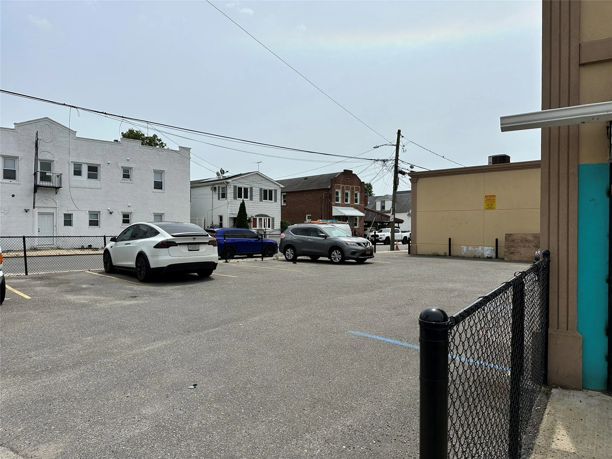Uncovered parking lot featuring a residential view Uncovered parking lot featuring a residential view