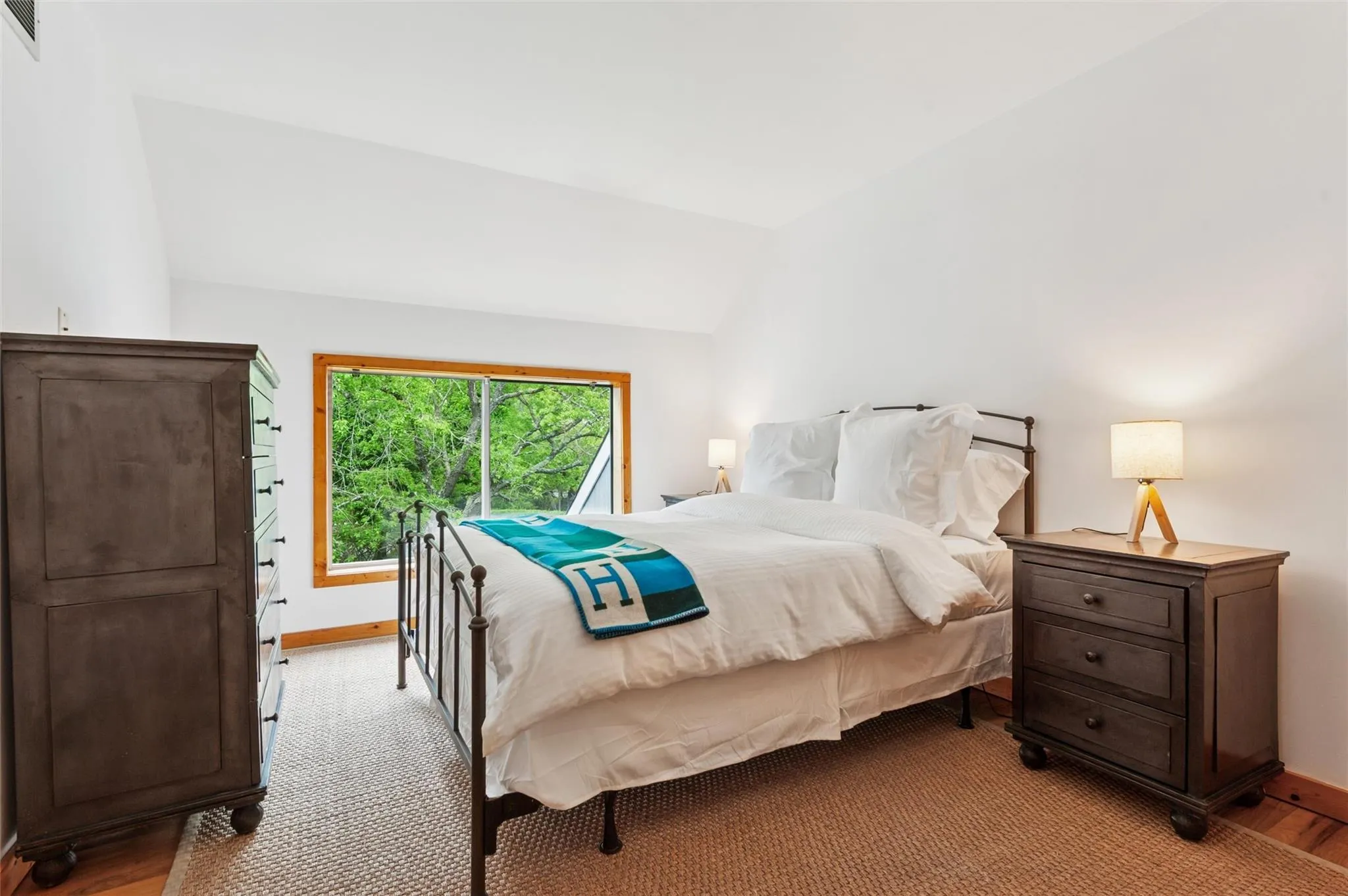 Bedroom with lofted ceiling, baseboards, and light wood-style flooring Bedroom with lofted ceiling, baseboards, and light wood-style flooring