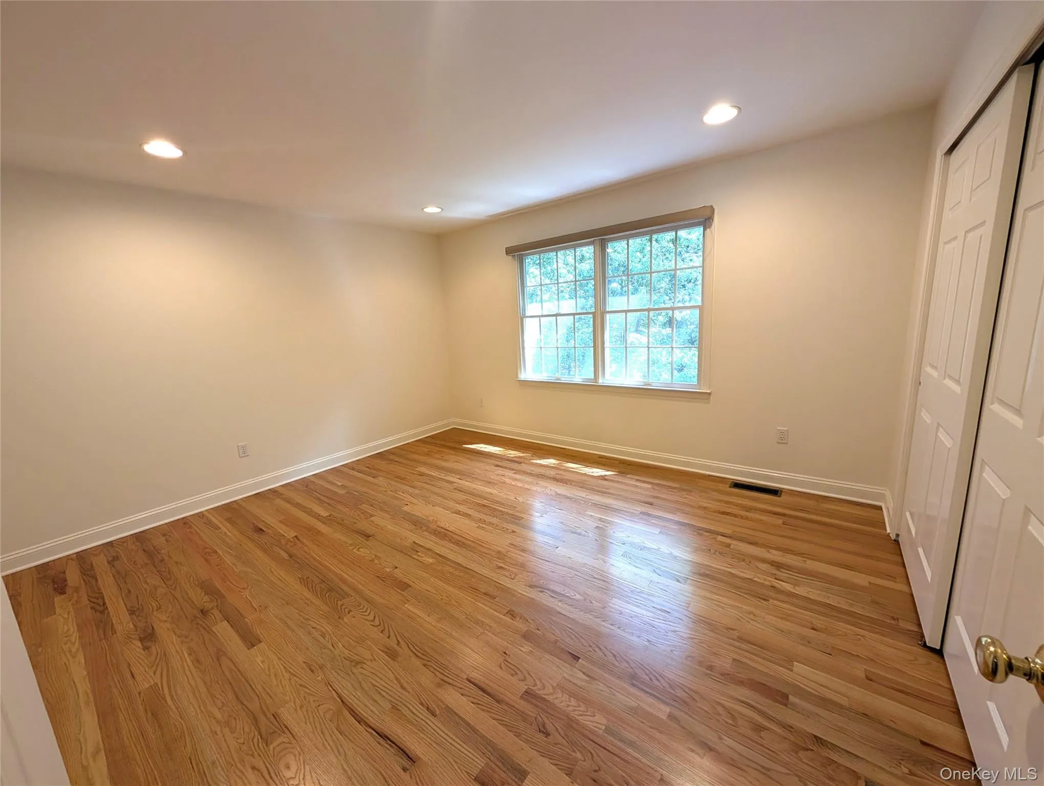 Unfurnished bedroom featuring recessed lighting, light wood-style floors, and a closet Unfurnished bedroom featuring recessed lighting, light wood-style floors, and a closet