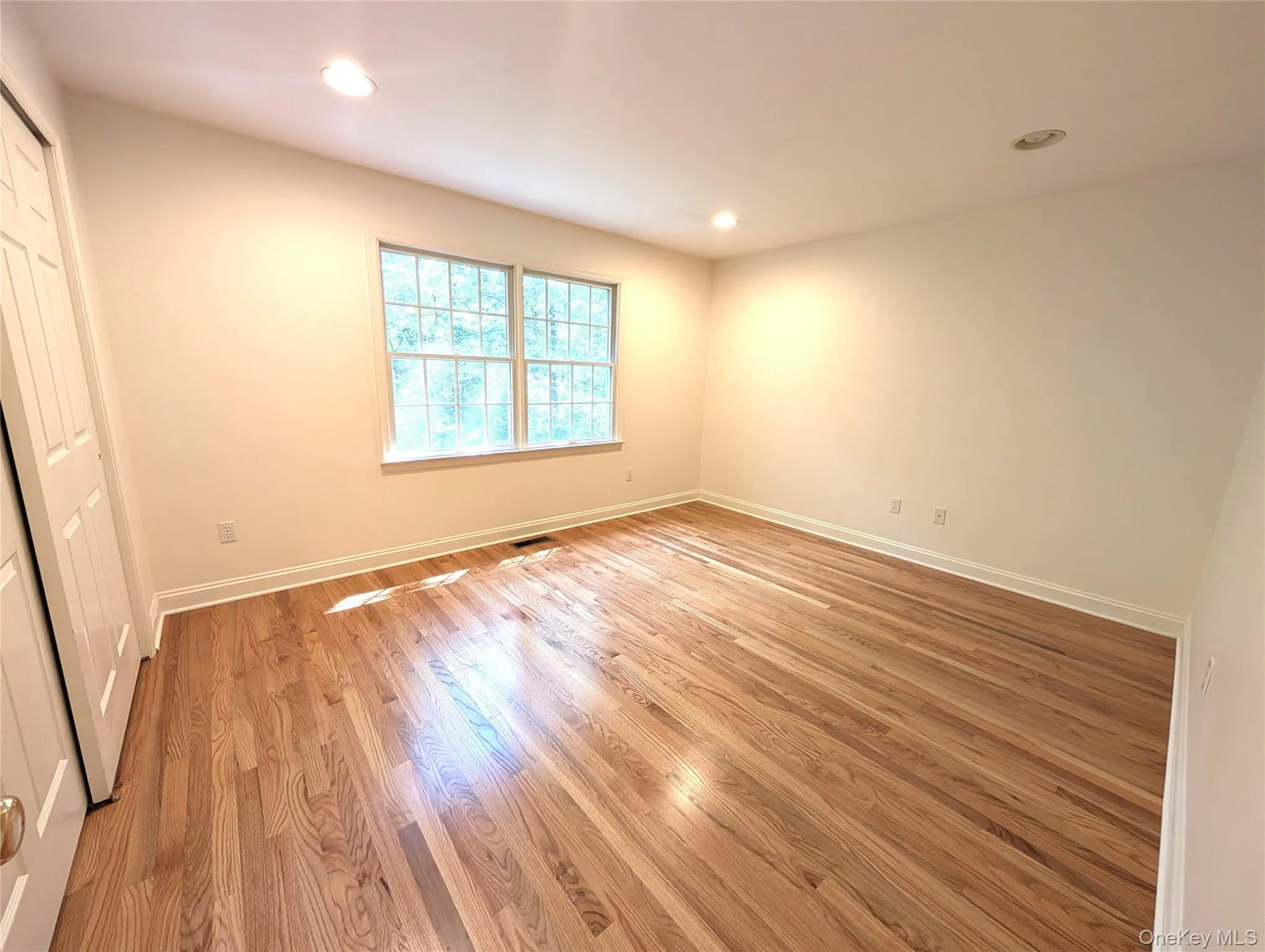 Unfurnished bedroom with light wood-style floors, recessed lighting, and a closet Unfurnished bedroom with light wood-style floors, recessed lighting, and a closet