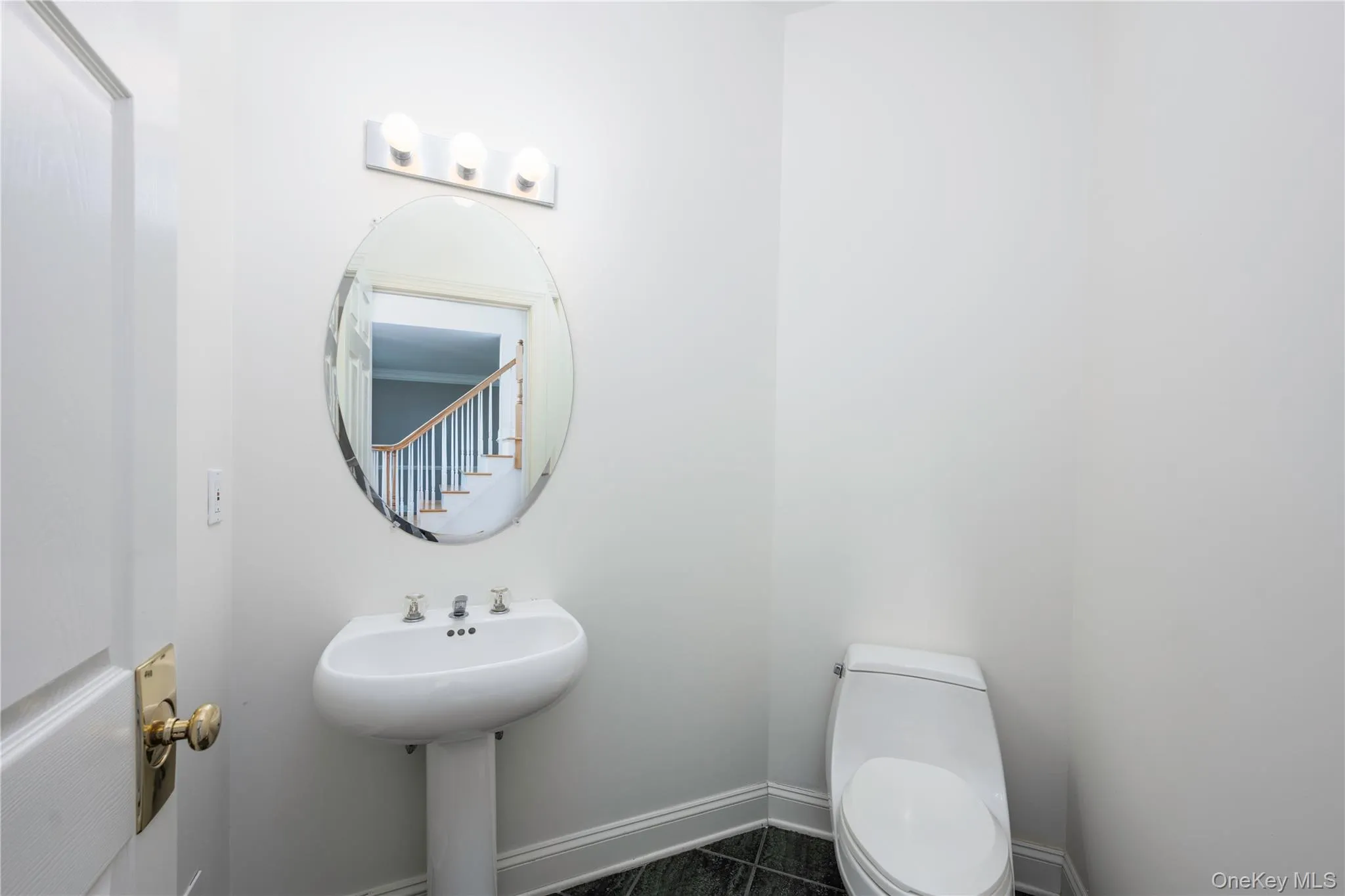 Half bath featuring toilet and baseboards Half bath featuring toilet and baseboards