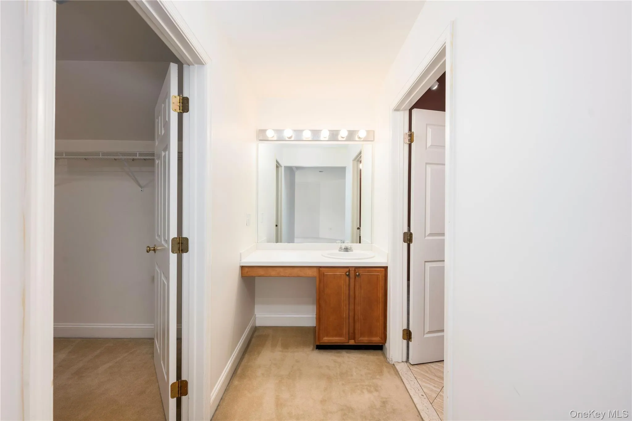 Bathroom featuring vanity and baseboards Bathroom featuring vanity and baseboards