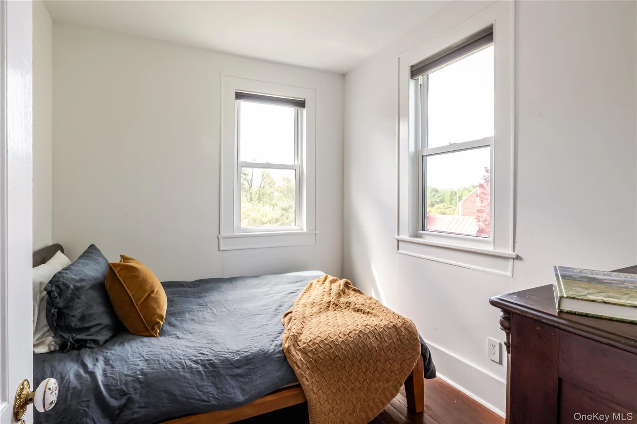 Bedroom with wood finished floors and baseboards Bedroom with wood finished floors and baseboards