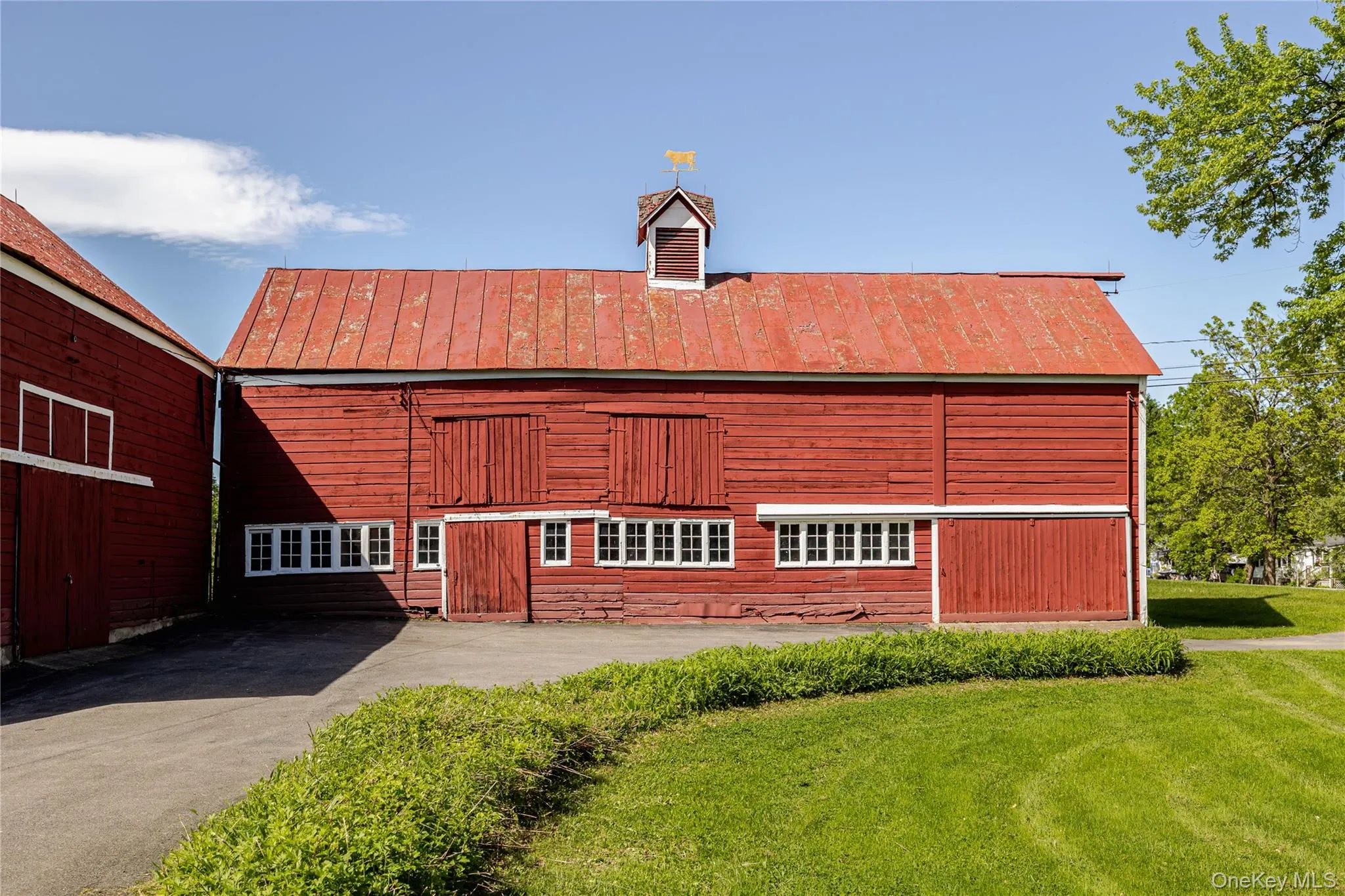 View of building exterior with a barn View of building exterior with a barn