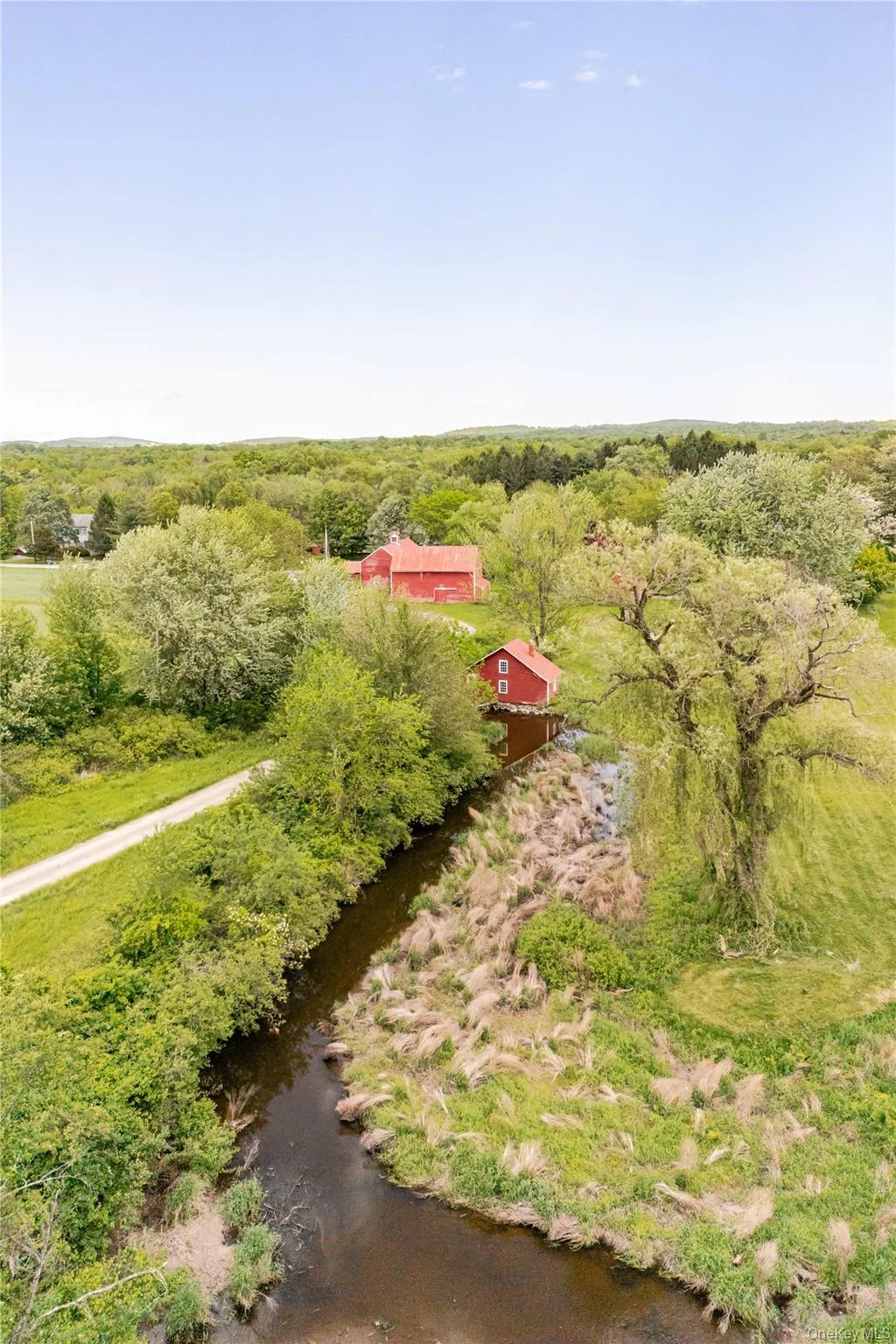 Aerial view of property and surrounding area with a heavily wooded area Aerial view of property and surrounding area with a heavily wooded area