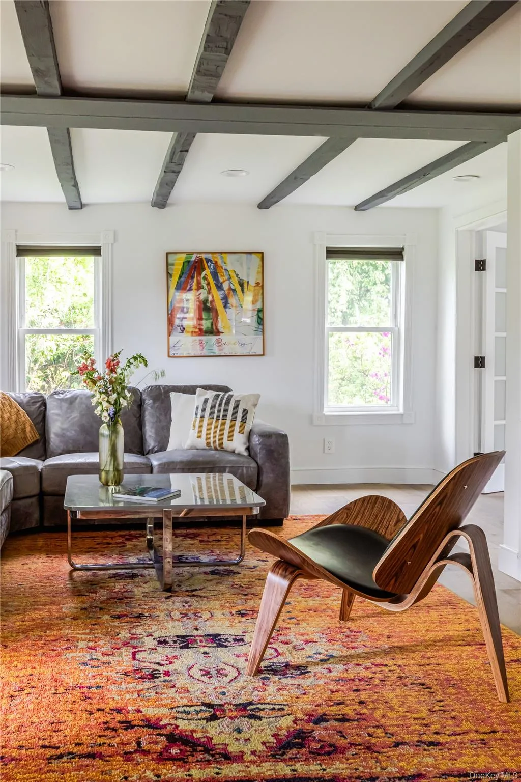 Living area with healthy amount of natural light, beamed ceiling, baseboards, and coffered ceiling Living area with healthy amount of natural light, beamed ceiling, baseboards, and coffered ceiling
